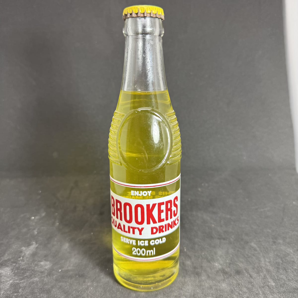 Ceramic Label Crown Seal. Brookers Cordials Yass. Original cap and contents. 200 ml. "Bullet" shape. (New South Wales)
