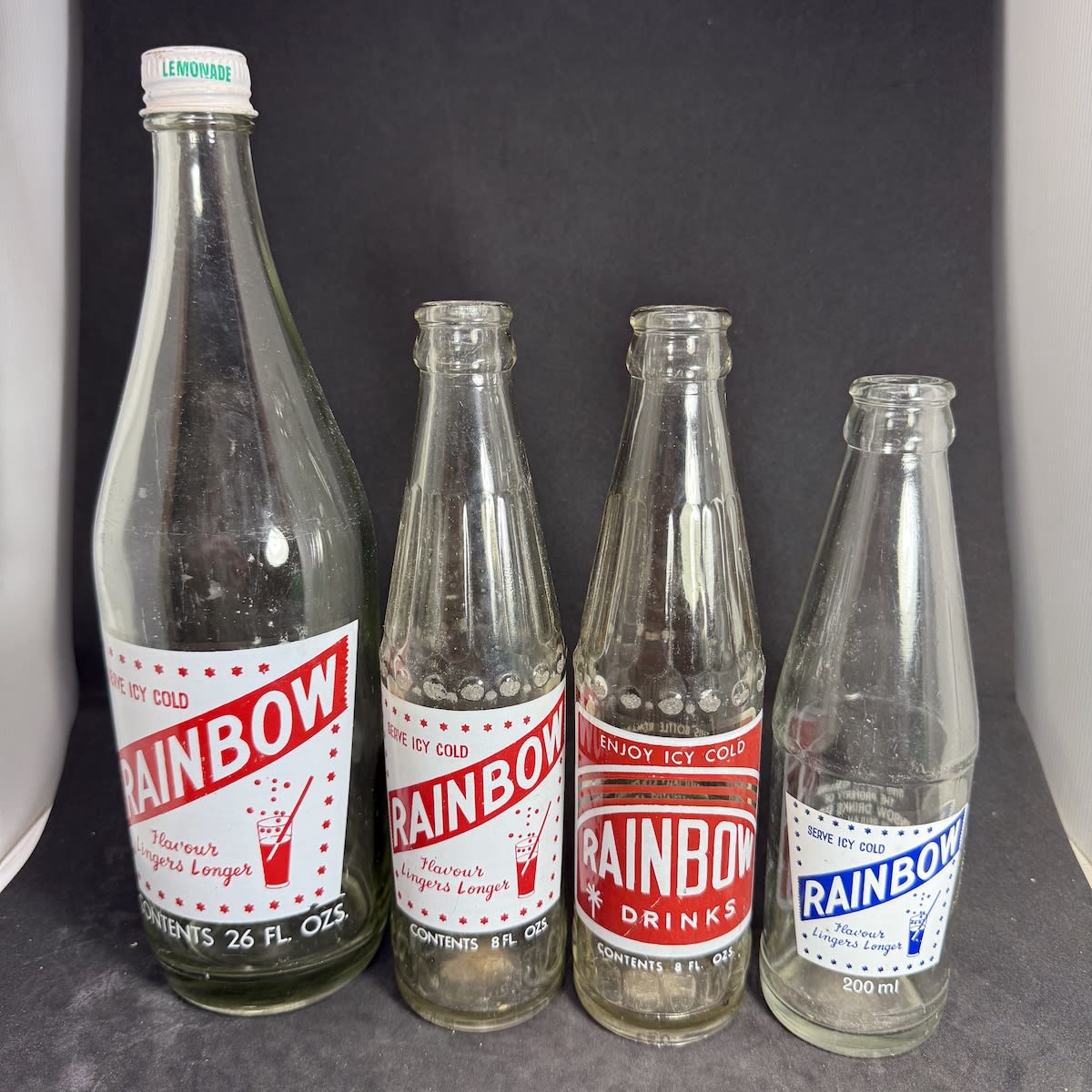 4 Ceramic Label Bottles. All Rainbow Drinks Pty Ltd, Maitland, SA. 26 oz Screw top, 2 different 8 oz Crown Seals and 200 ml Crown Seal. (South Australia)