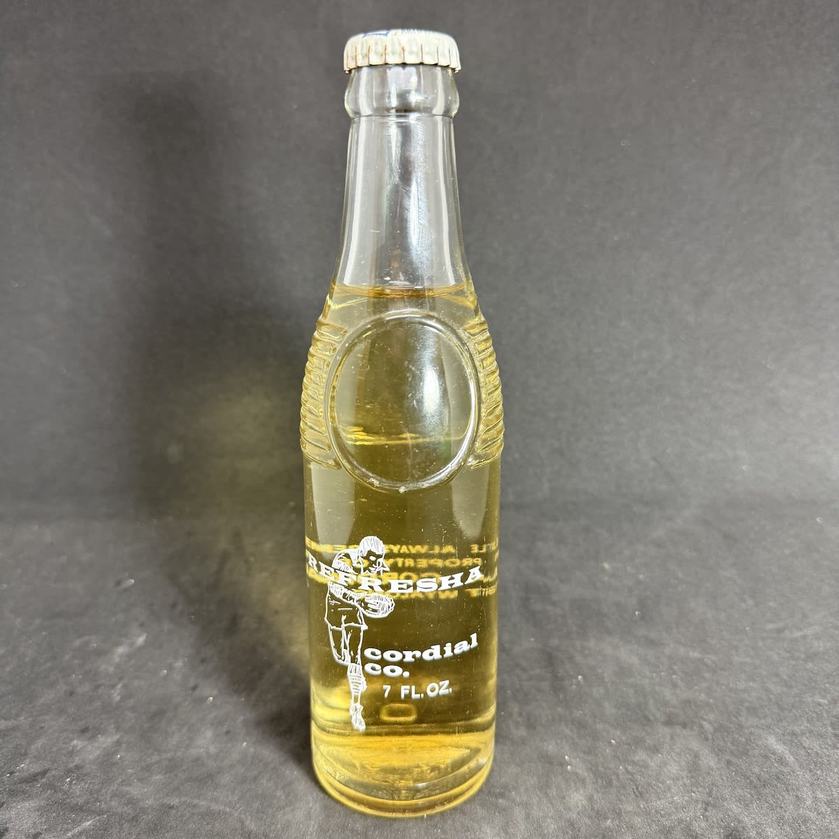 Ceramic Label Crown Seal. Refresha Cordial Co., West Wyalong. Rugby Player. 7 oz "Bullet" type. Still with contents and sealed with Refresha branded cap. (New South Wales)