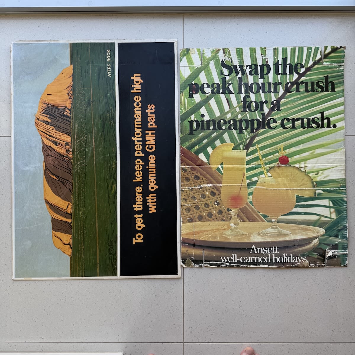2 Cardboard Travel related Posters: Ayers Rock, To get there, keep performance high with genuine GMH Parts Ansett Well earned Holidays.