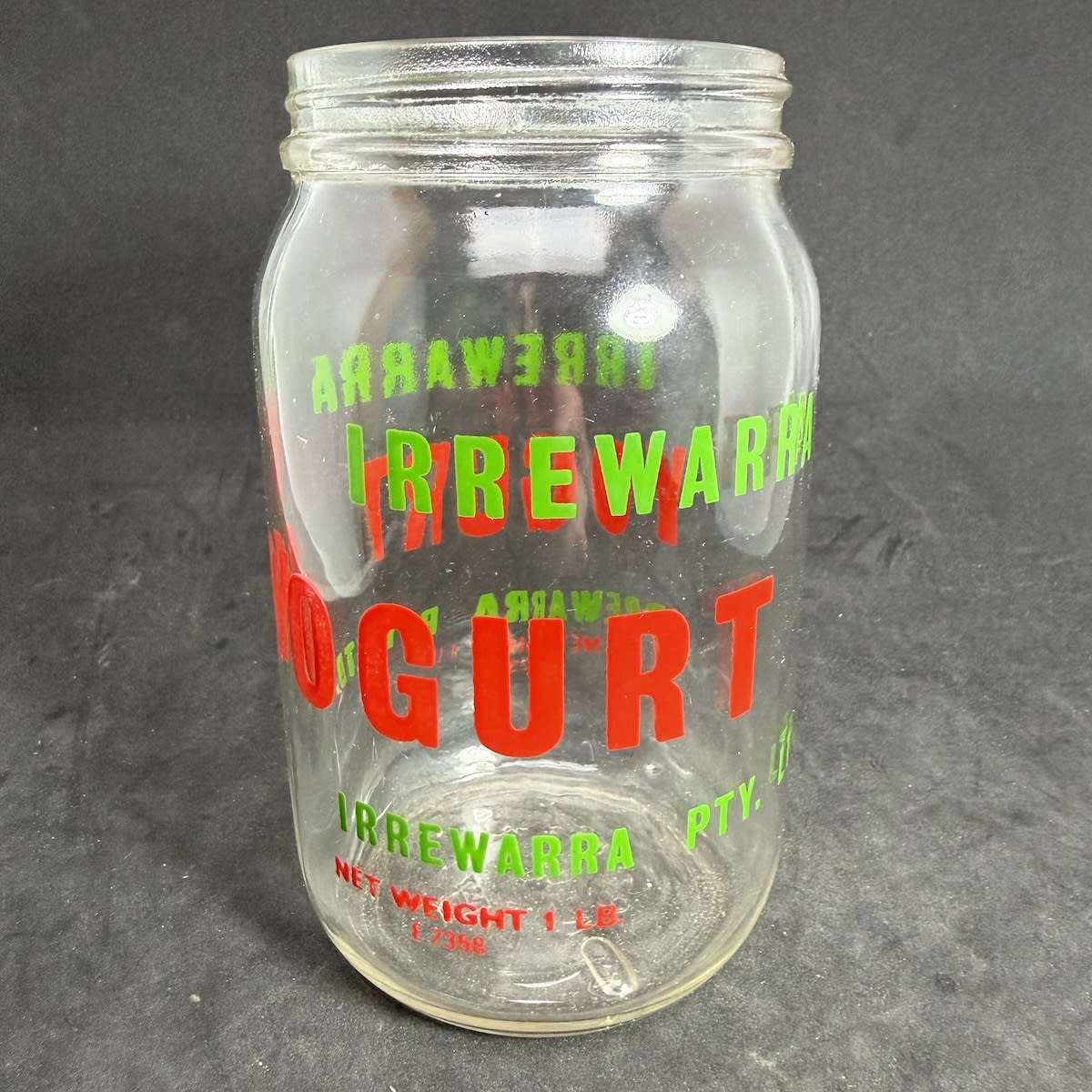 Ceramic Label Yoghurt Jar. Irrewarra Yogurt. Irrewarra Pty Ltd. 1 lb. Red & Green print. Different variation to ones we have previously sold. This one without "The Wonder Food" on it. (Victoria)