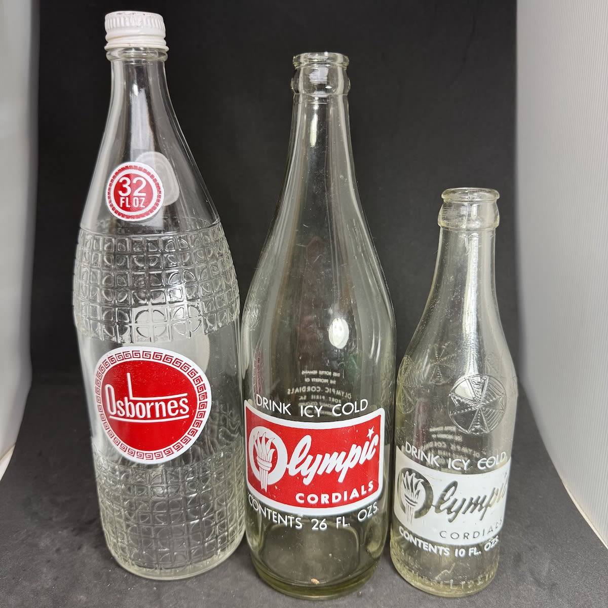 3 Ceramic Label Aerated Waters: Olympic Cordials Port Pirie 26 oz Olympic Cordials 10 oz (on an F. J. Schembri, Ethelton embossed bottle) Osbornes 32 oz. (South Australia)