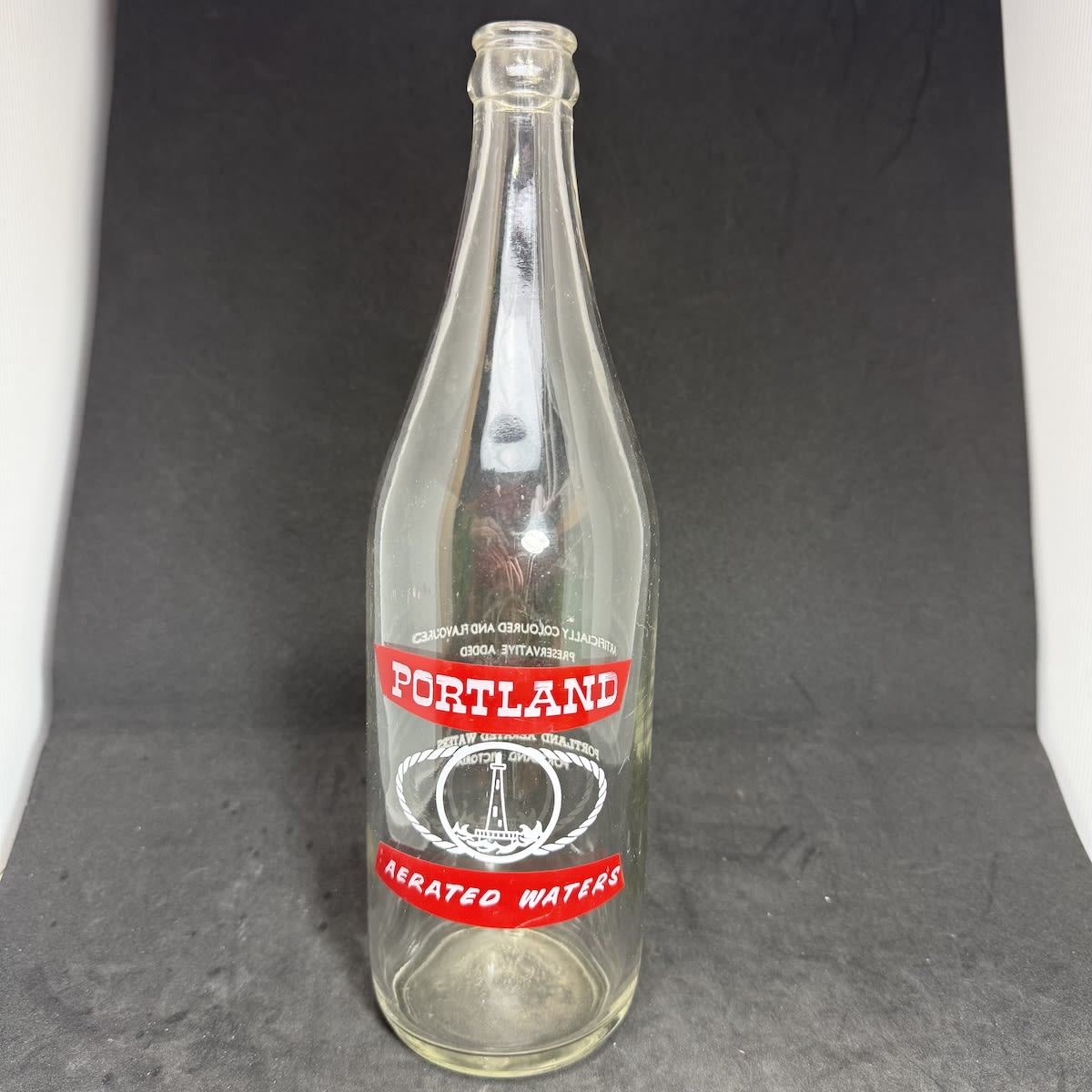 Ceramic Label Crown Seal. Portland Aerated Waters. Lighthouse. 26 oz. Red & White print. (Victoria)