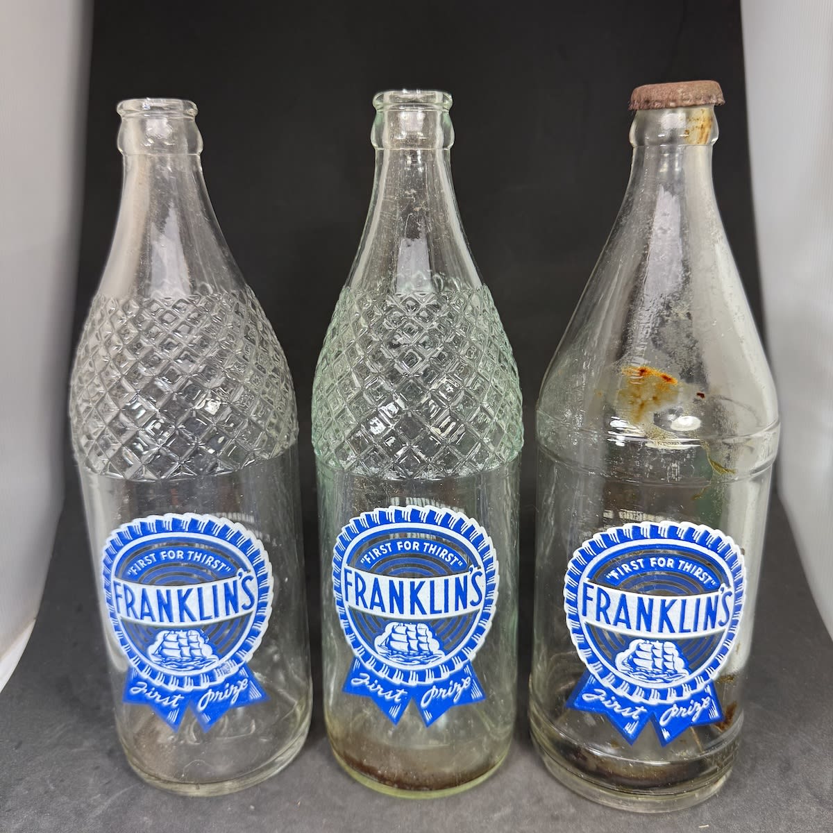 3 different Franklin's Geelong Ceramic Label Crown Seals: 24 oz Fancy shoulder with Net Contents on back; 24 oz without net contents; 26 oz with raised ridges. J. T. Franklin & Co Pty Ltd, Fenwick Street. (Victoria)
