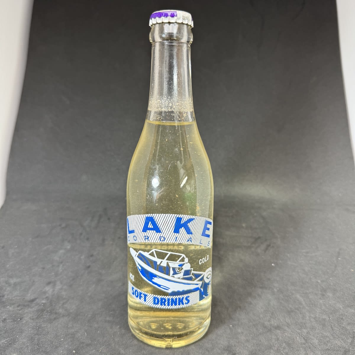 Ceramic Label Crown Seal. Lake Cordials. Lake Cargellico. Speedboat. 10 oz (size not printed). Sealed with original Lake Cordials cap for Passionfruit Drink. (New South Wales)