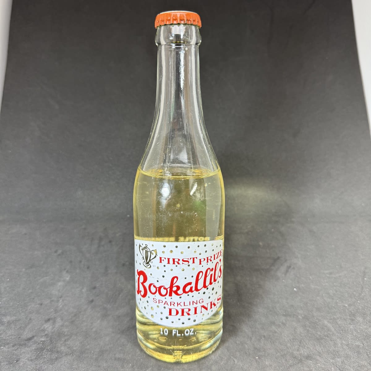 Ceramic Label Crown Seal. Bookalil's Sparkling Drinks. 10 oz. Trophy. A. Bookalil Cooma. Sealed with original A. Bookalil Dry Ginger Ale Cap. (New South Wales)