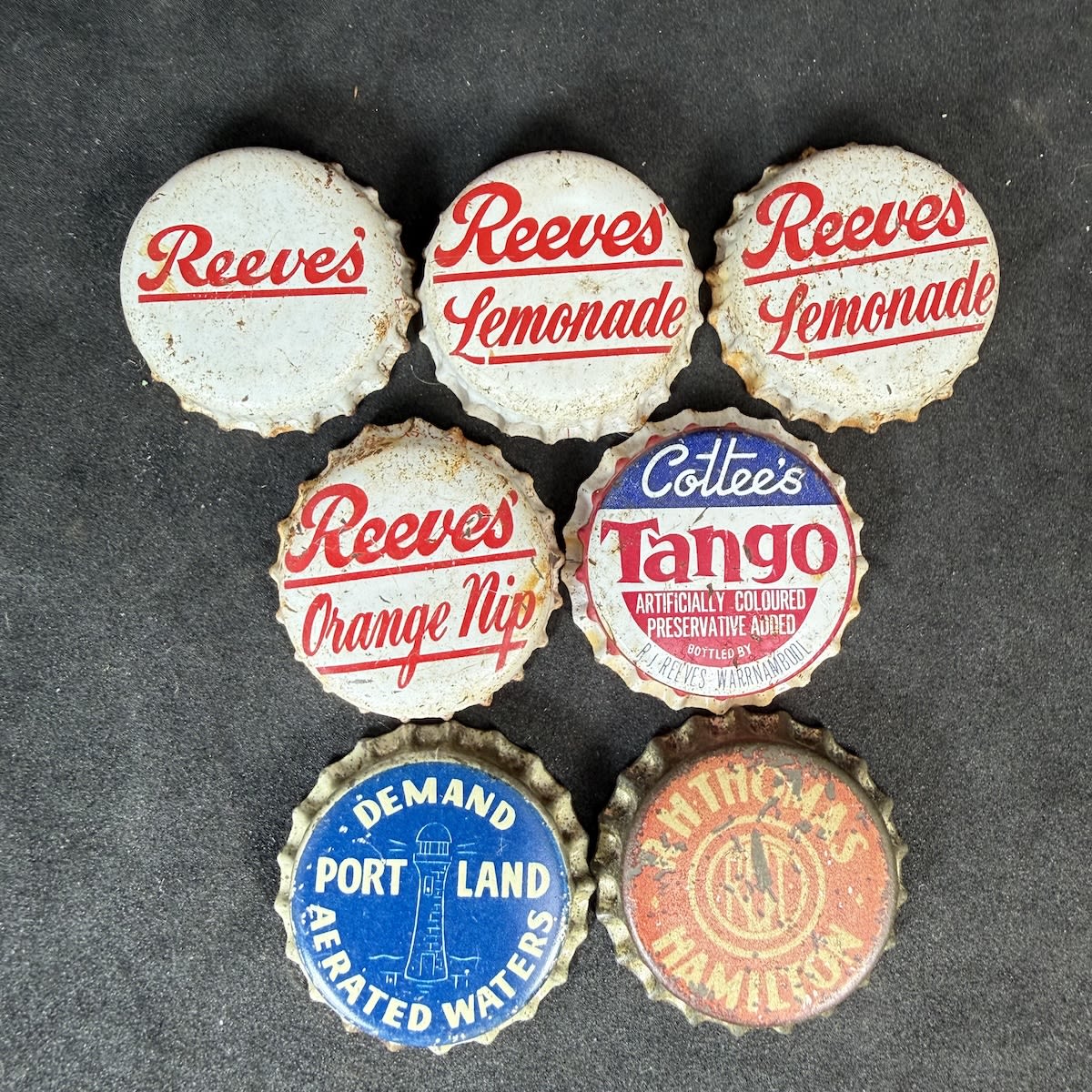 7 Crown Seal Caps from South West Victoria: Reeves; 2 x Reeves Lemonade; Reeves Orange Nip; Cottees Tango bottled by R. J. Reeves Warrnambool; Portland Aerated Waters; R. H. Thomas, Hamilton. (Victoria)