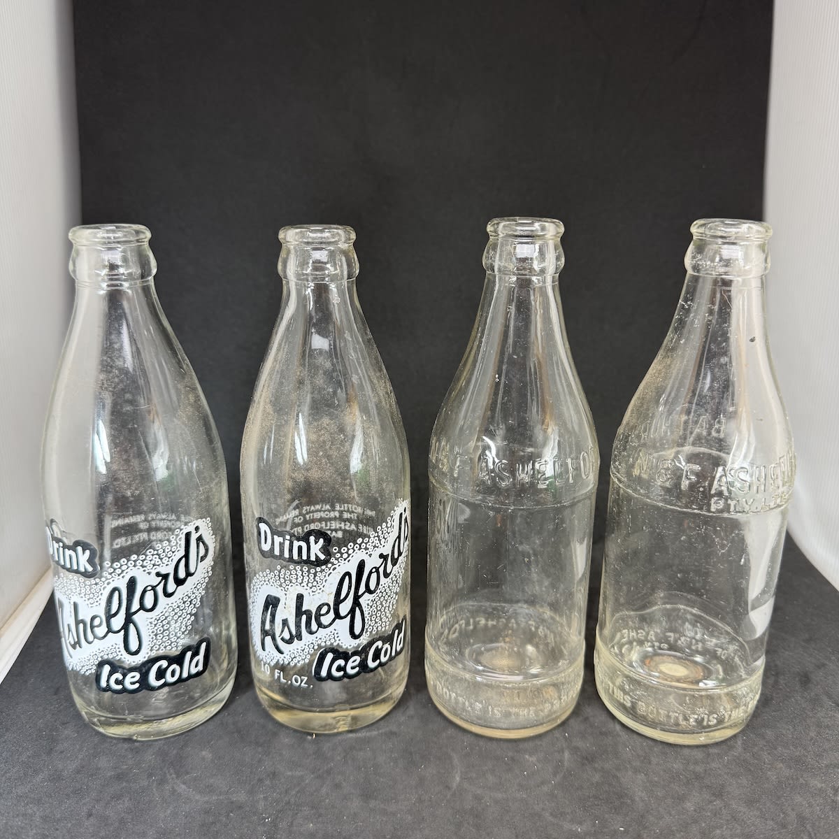 4 different N. & F. Ashelford, Bathurst 10 oz Bottles: Ceramic labels with and without size printed; Embossed just Ashelford and embossed with Pty Ltd added. (New South Wales)