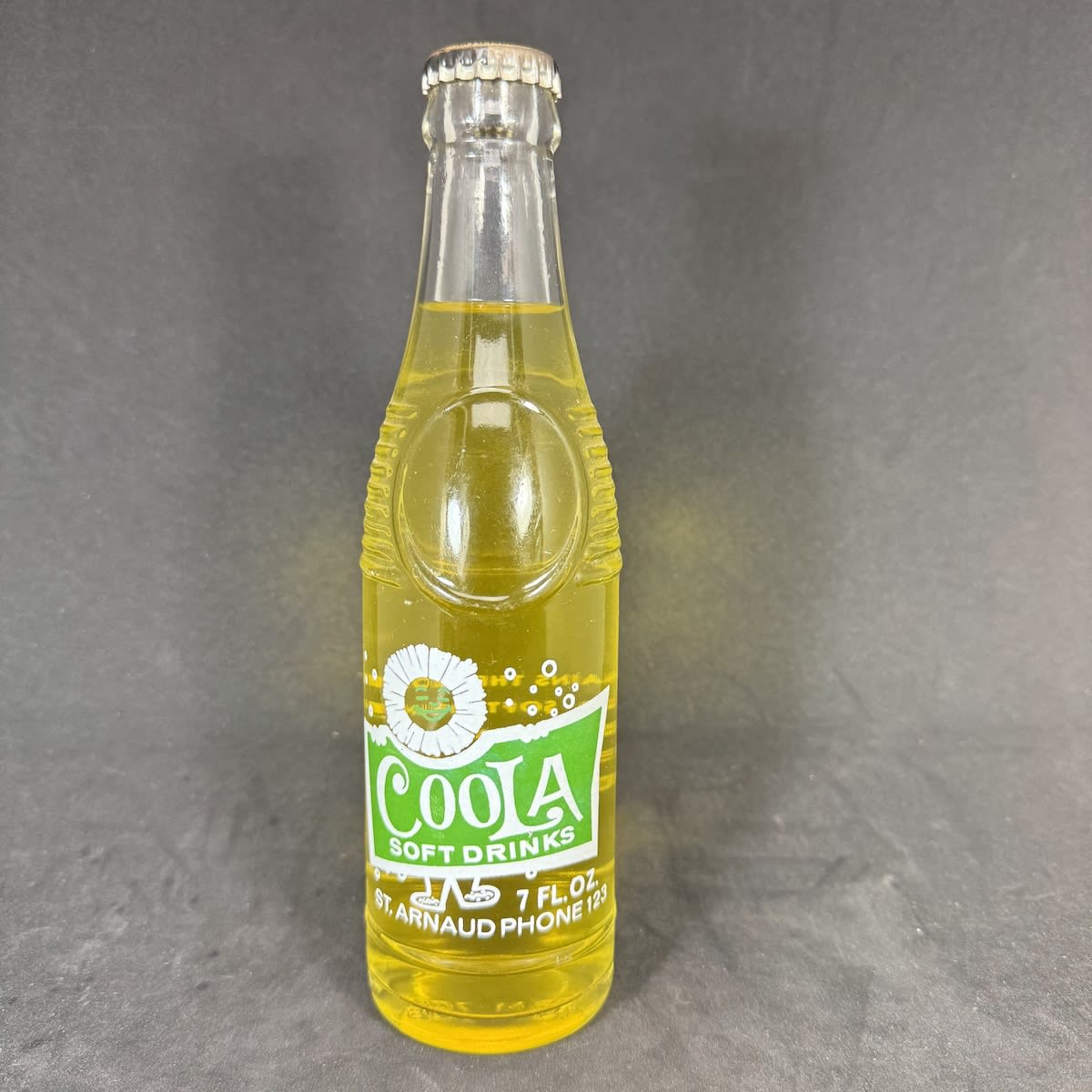 Ceramic Label Crown Seal. Coola Soft Drinks. Green & White. 7 oz. Bullet type. Still sealed with contents and generic Pineapple Flavour cap. (Victoria)