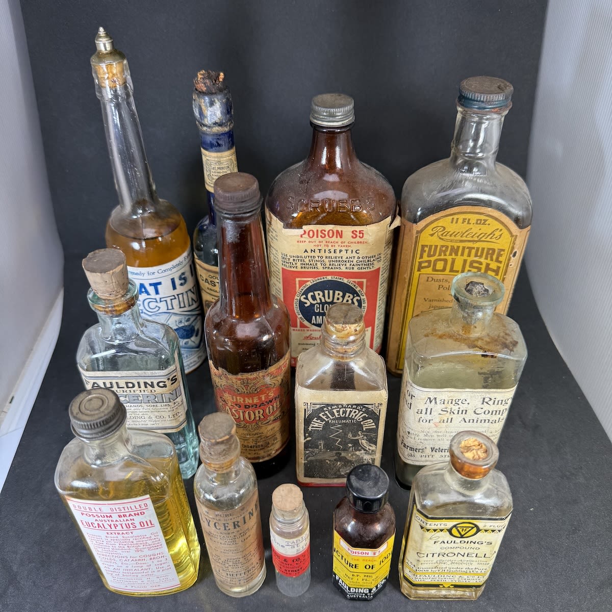 13 Labelled Bottles: Insectine; Mortons Castor Oil; Burnets Castor Oil; Possum Brand Eucalyptus; Scrubbs Ammonia; Electric Oil; Fauldings; Rawleighs; etc.