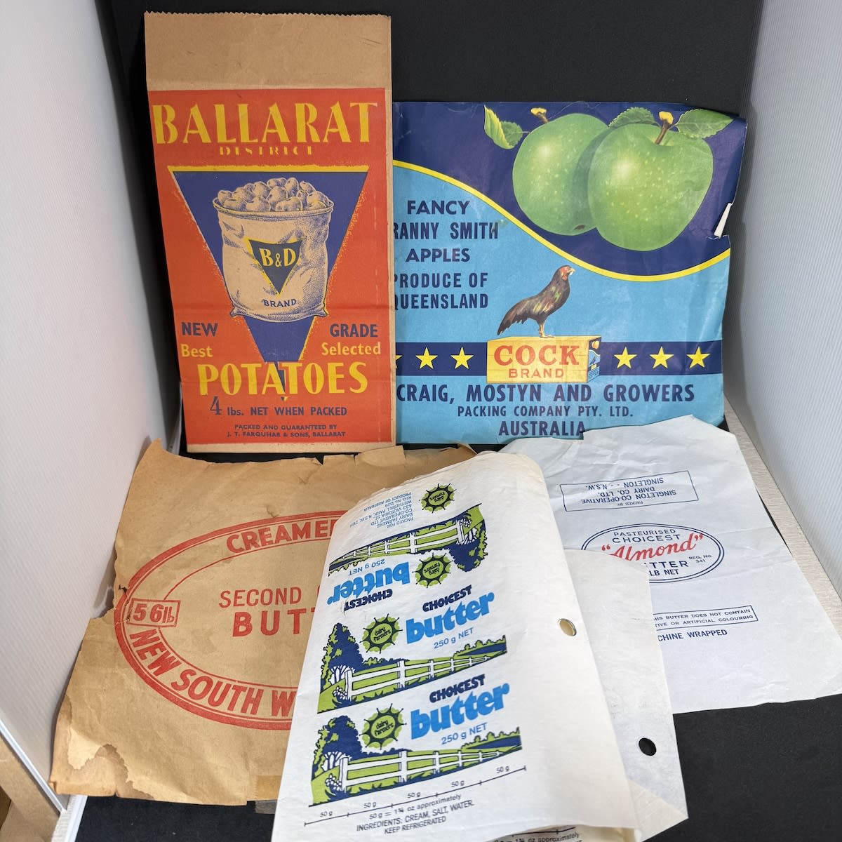Ephemera Group: Cock Brand Granny Smith Apples Label; Bag, Ballarat Potatoes, Farquhar & Sons; Singleton Co-operative Dairy "Almond" Butter; NSW Second quality butter label; Uncut sheet of 8 butter labels from Dairy Farmers Co-op.