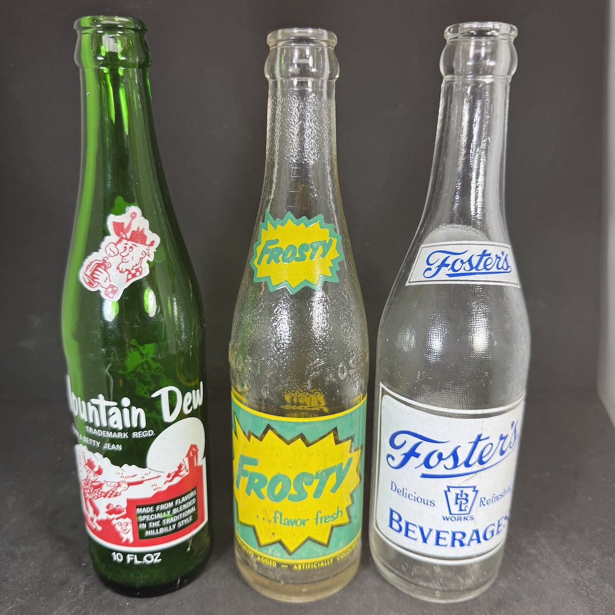 3 Ceramic Label Crown Seals: Mountain Dew; Frosty; Foster's Beverages.