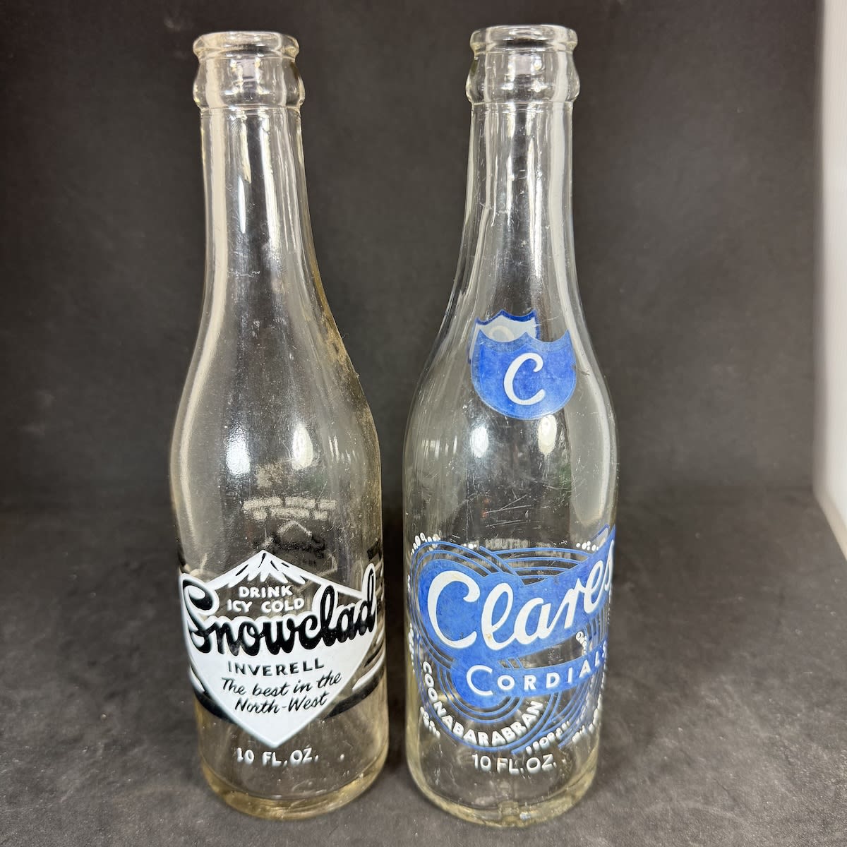 2 Ceramic Label Crown Seals: Snowclad Products Inverell; Clares Cordials, J. T. Clare, Coonabarabran. 10 oz. (New South Wales)