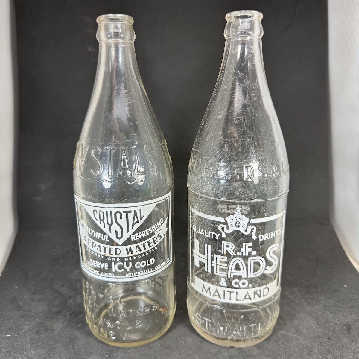 2 Embossed & Ceramic Label Crown Seals: Crystal Aerated Waters Newcastle Sydney; R. F. Heads & Co Maitland. 24 oz. White Prints. (New South Wales)