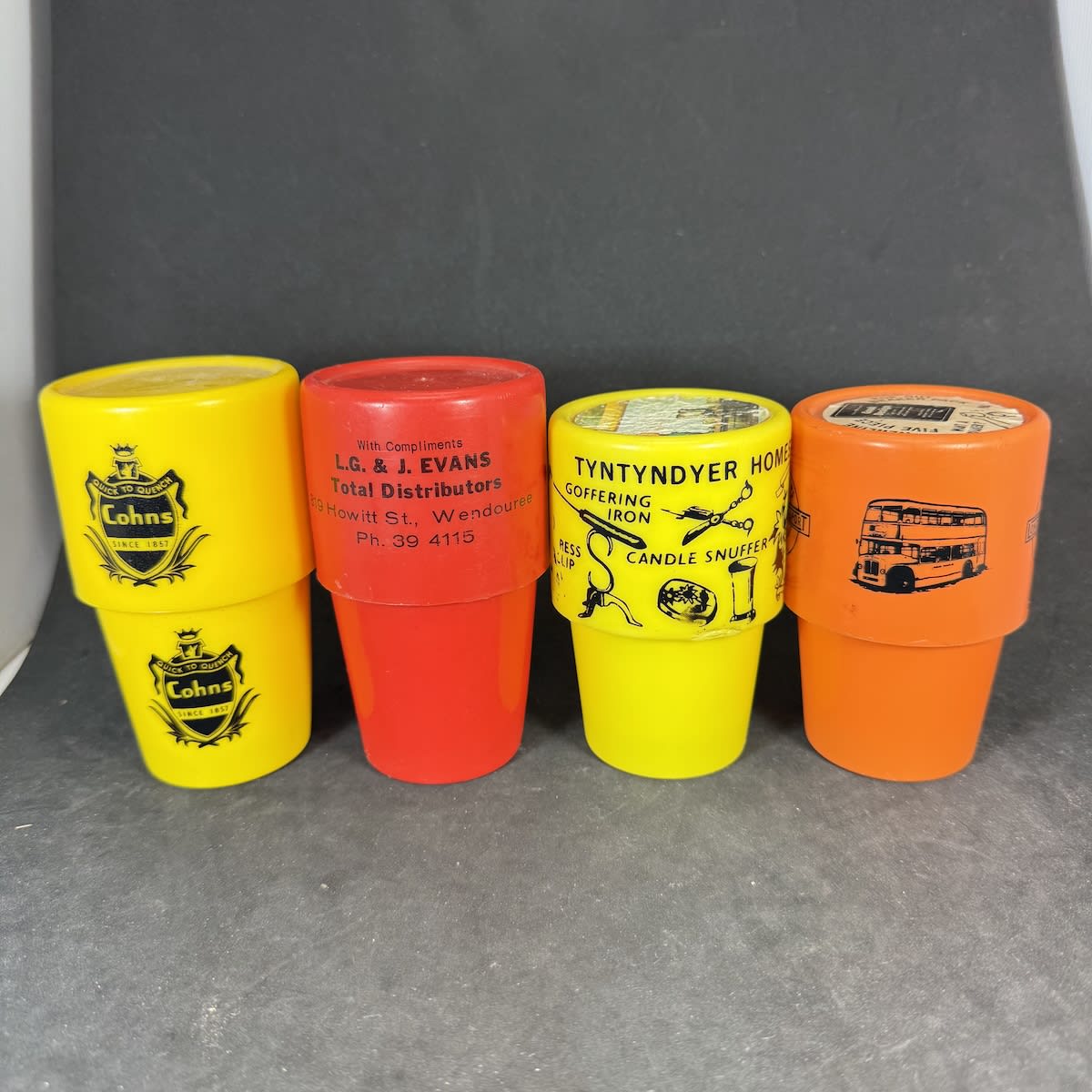 4 Plastic Beaker sets. Advertising for Cohns Soft Drinks; L. G. & J. Evans, Total Distributors, Wendouree; Tyntynder Homestead; London Transport Bus Tours Victoria.