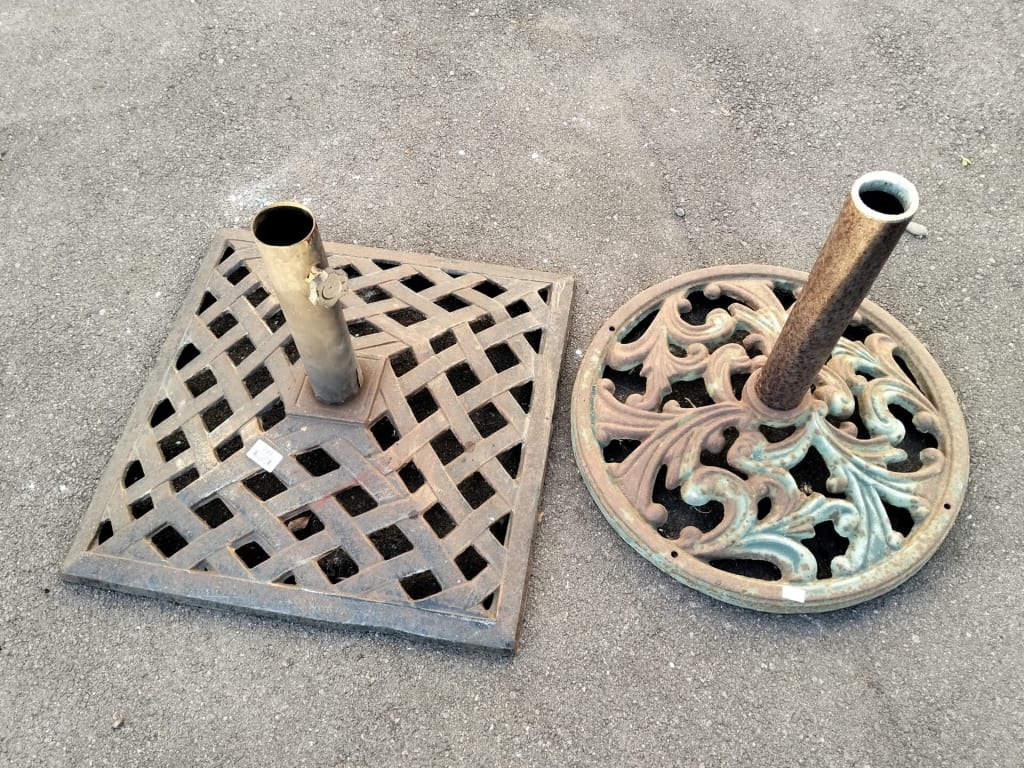 PAIR OF IRON UMBRELLA STANDS — NZ auction result