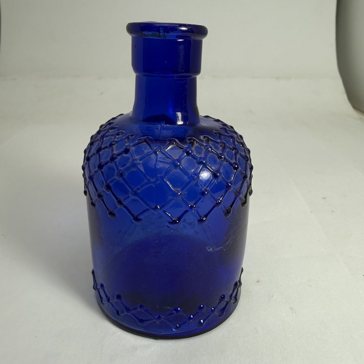 Poison. Lysol type jug poison. Cross hatching around the shoulder and base edge. Faint M to base.