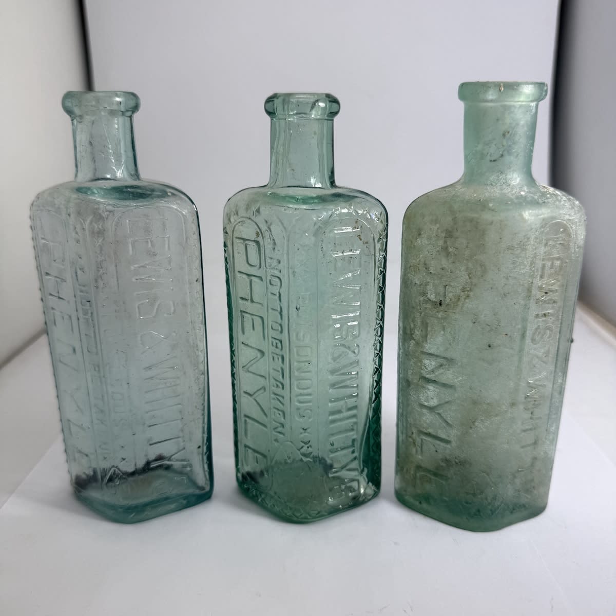 3 Variations of small Lewis & Whitty's Phenyle Bottles. (Victoria)