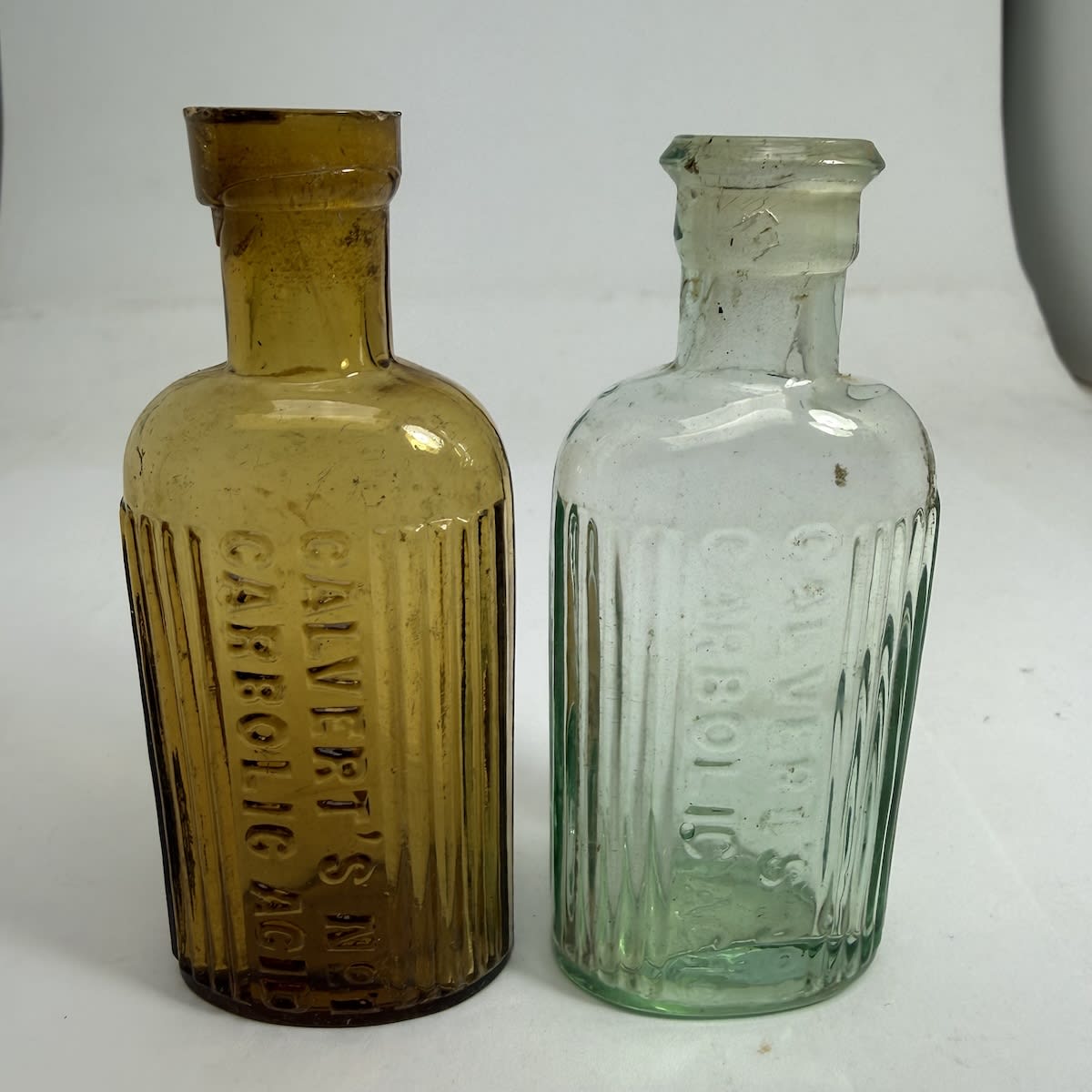 2 Poisons. Both Calvert's No 1. Carbolic Acid. Amber & Aqua. 1 oz. 90 - 93 mm.