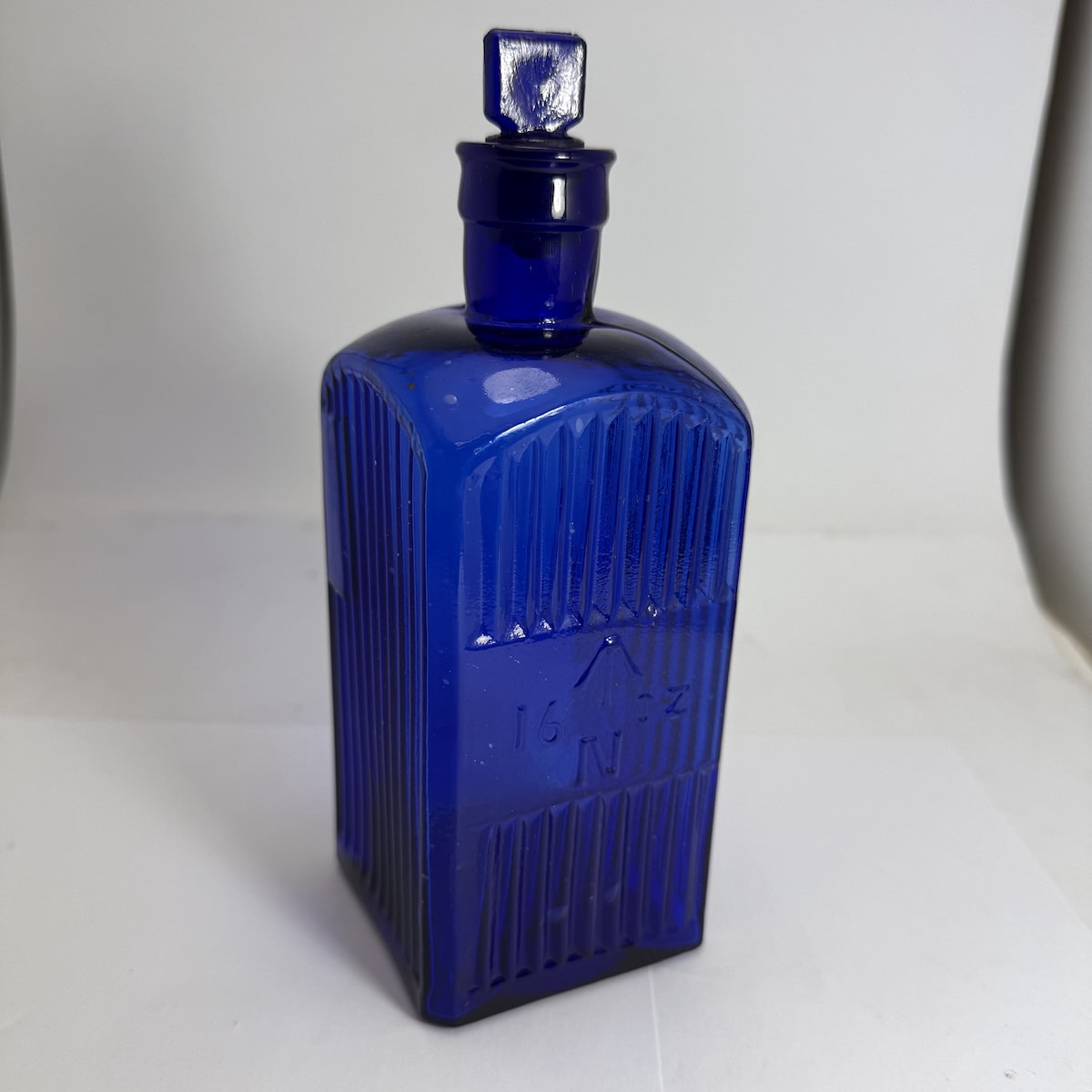 Poison. Admiralty Poison. Cobalt. 16 oz. Broad Arrow. Square. Original stopper. (United Kingdom)