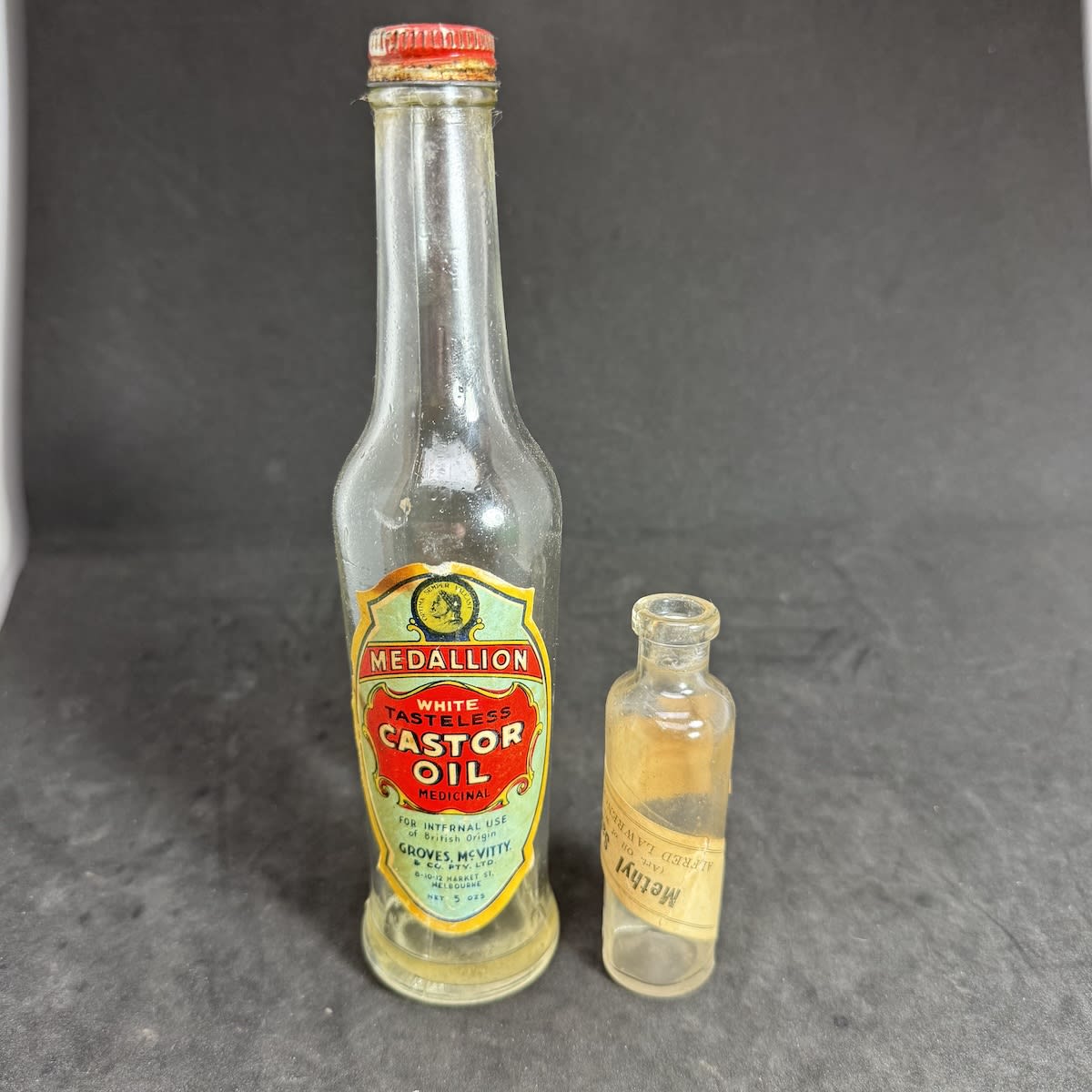 2 Labelled Bottles: Medallion White Tasteless Castor Oil, Groves McVitty & Co Pty Ltd Melbourne; Methyl Salicylate, Alfred Lawrence & Co Ltd.