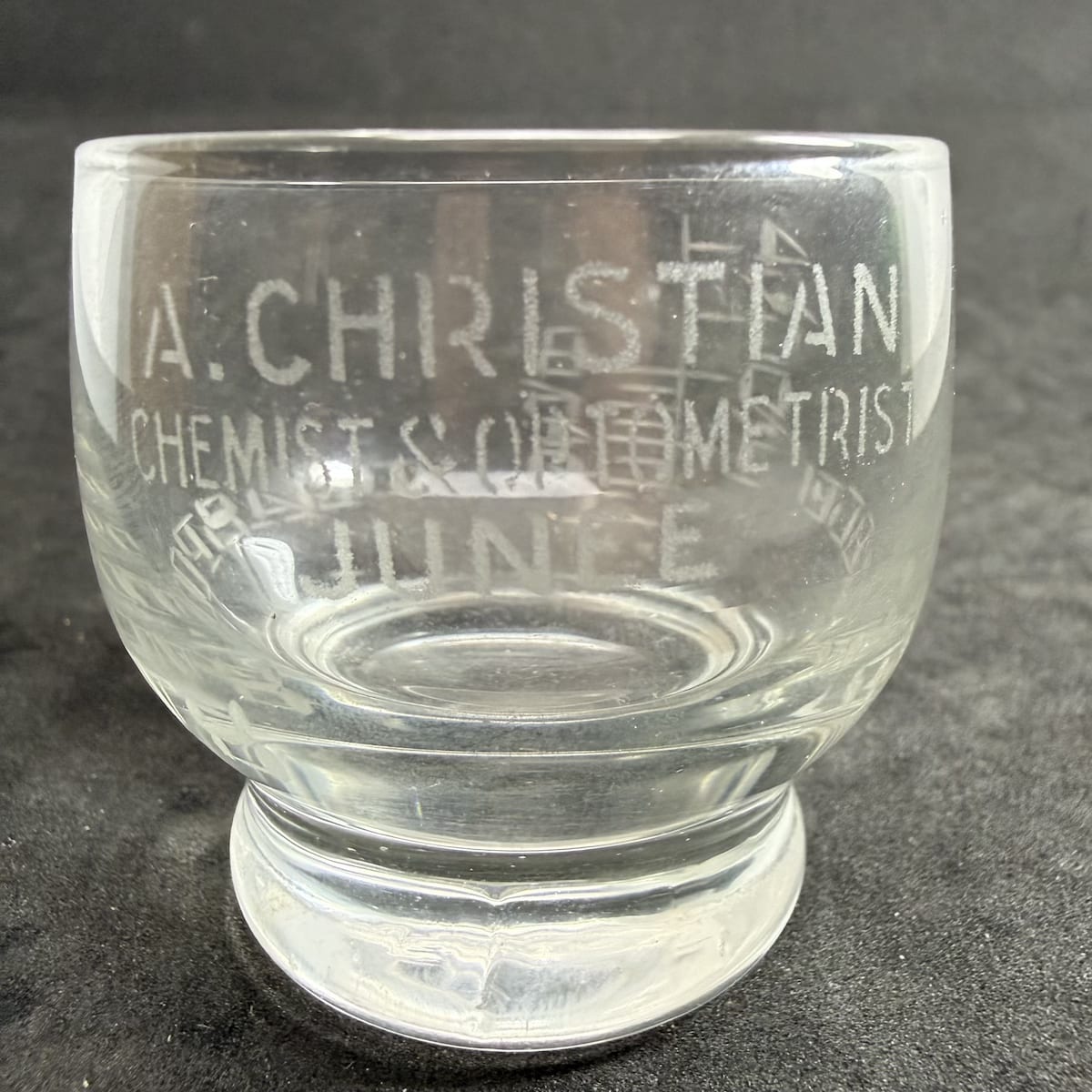 Dose Cup. A. Christian, Chemist & Optometrist, Junee. Squat cup type. 4 Tablespoon size. (New South Wales)