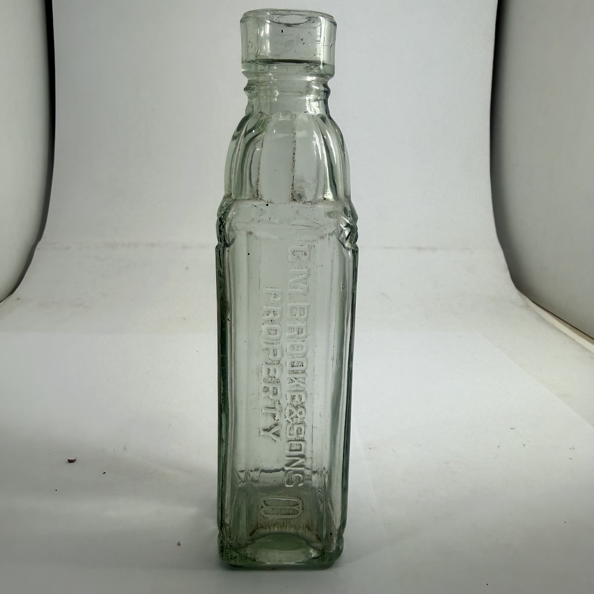 Sample Cordial. C. M. Brooke & Sons Property. Double oval shape embossed. Square with fancy base edge shoulder and neck. Small size, about 4 oz. 162 mm.