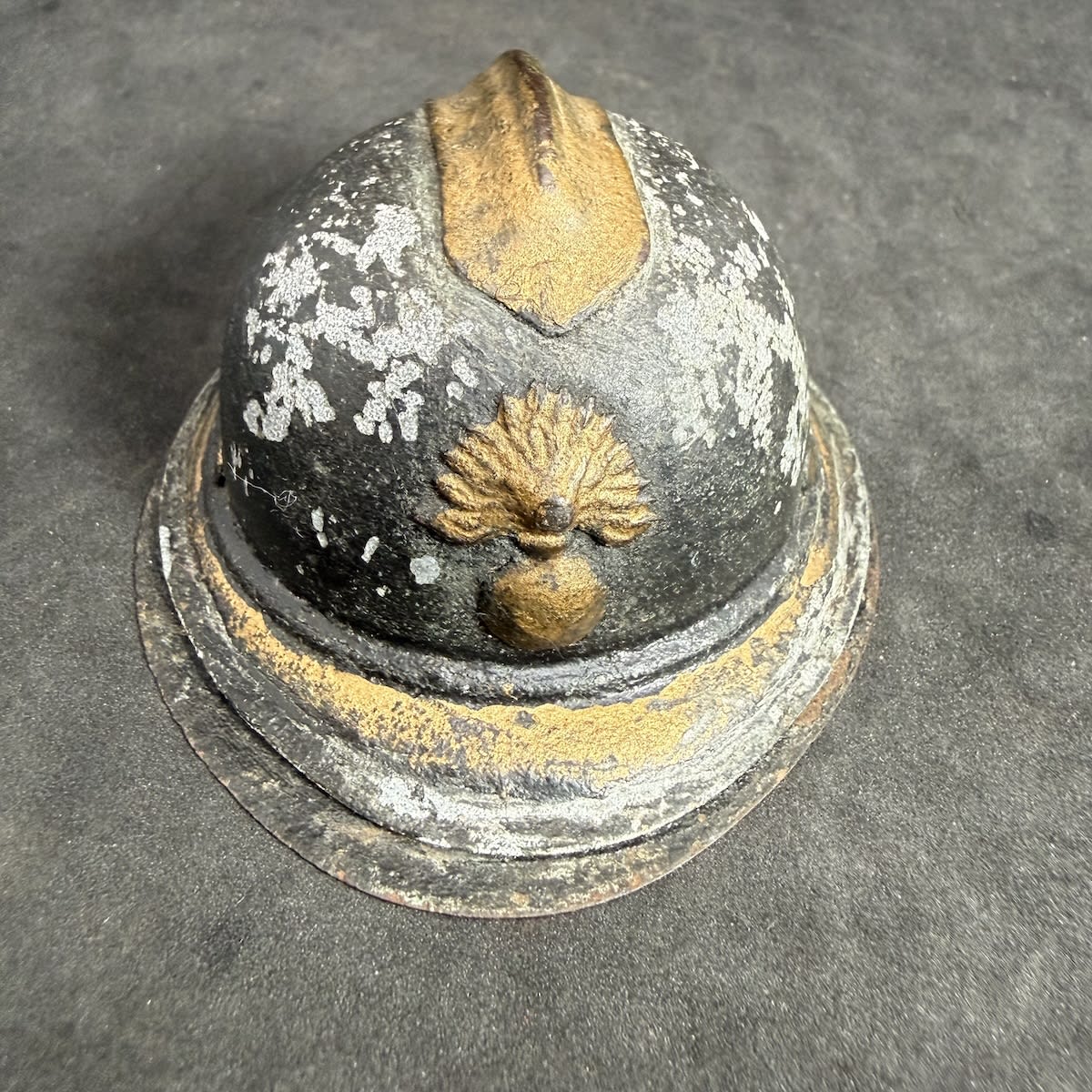 Inkwell. Trench art style inkwell in the shape of a French Adrian Helmet. Flaming bomb logo to front. Helmet hinges up to reveal an inkwell on a flat base.