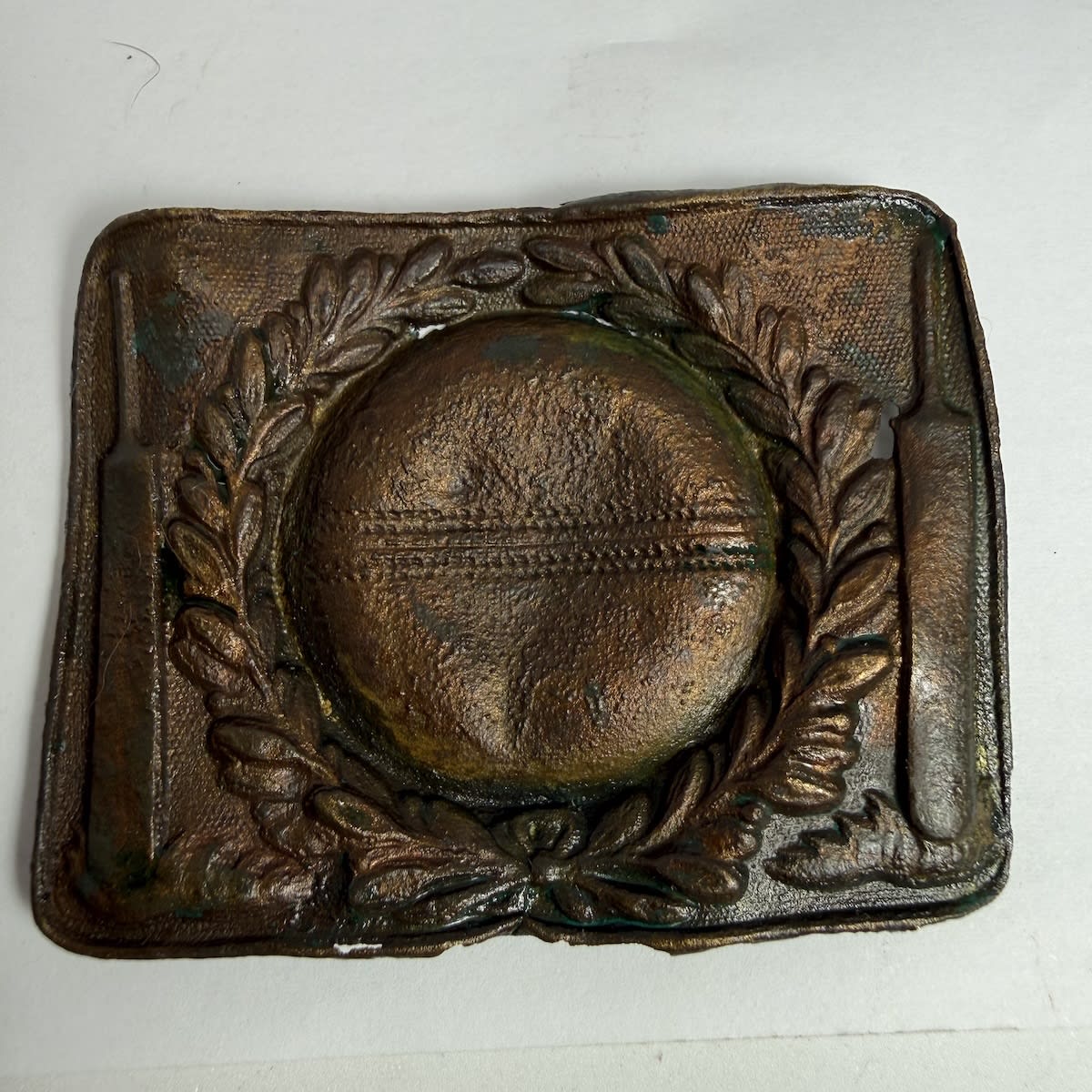 Cricket Belt Buckle. Large cricket ball to centre with a wreath around it. Bats either side. Bit of gilt on the back.