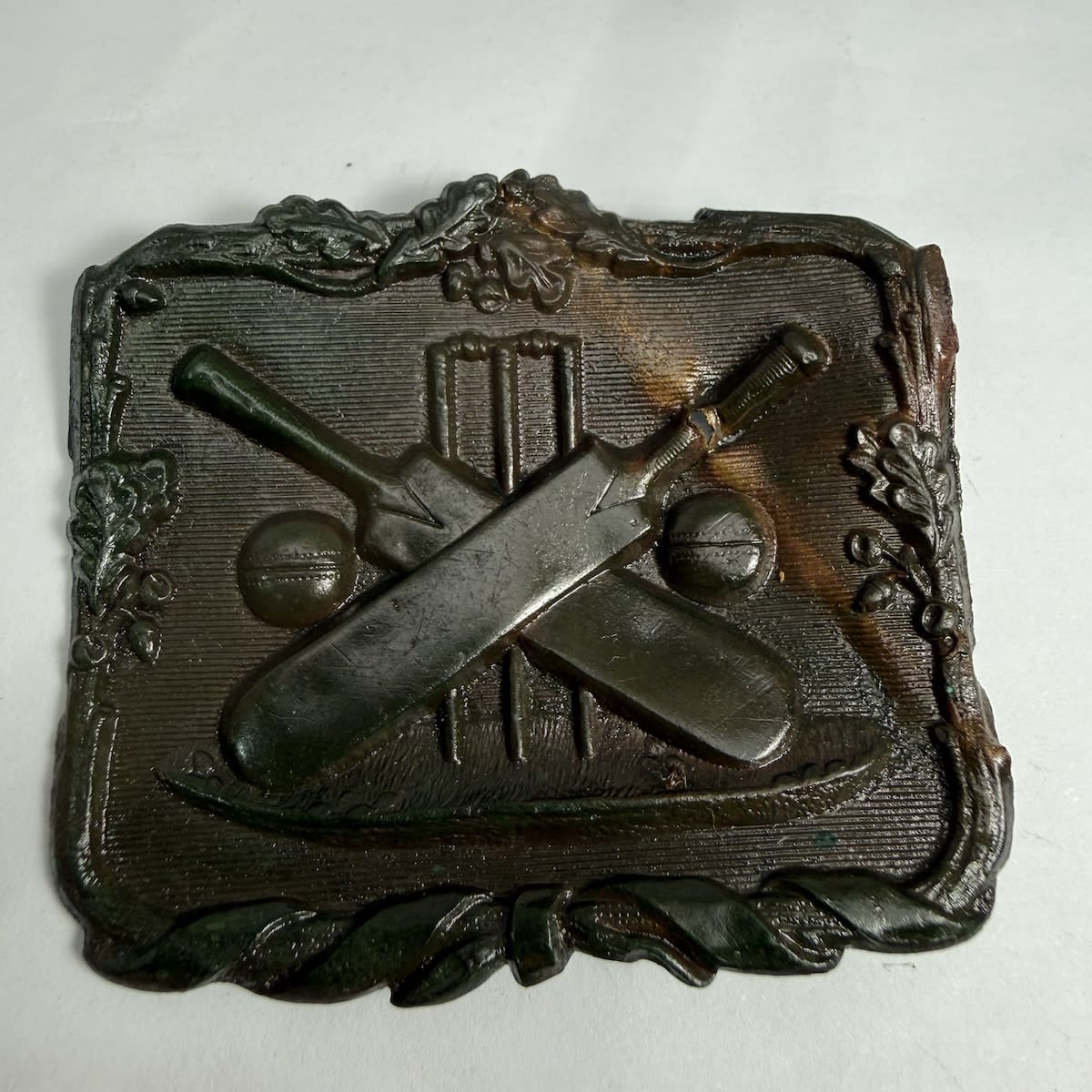 Cricket Belt Buckle. Crossed Bats with Cricket Balls in Front of stumps.