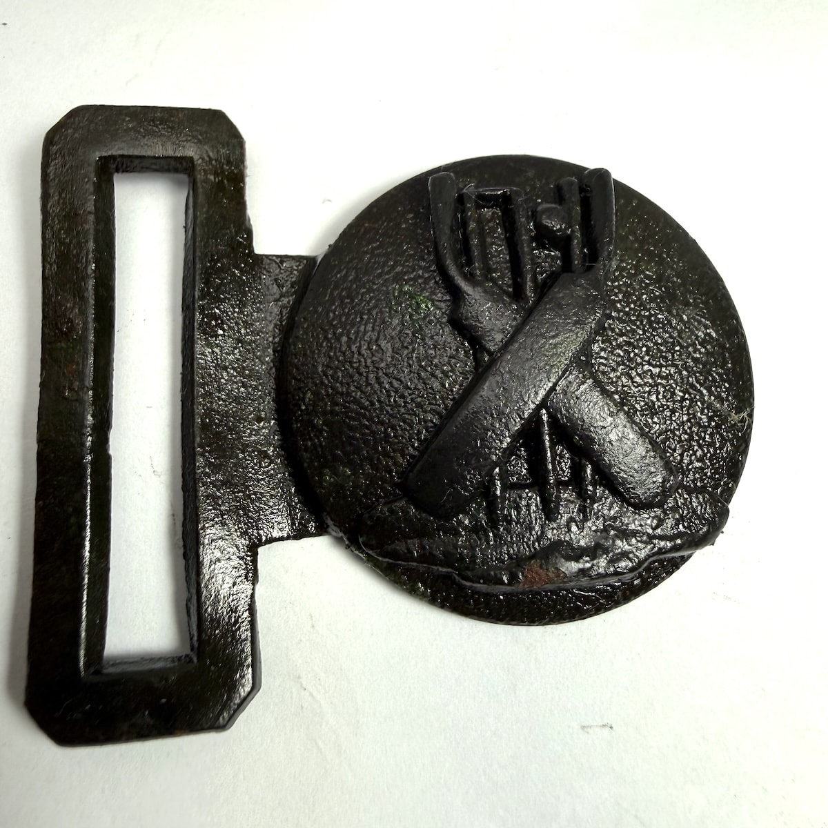 Cricket Belt Buckle. Crossed bats in front of stumps which have a ball going through them.