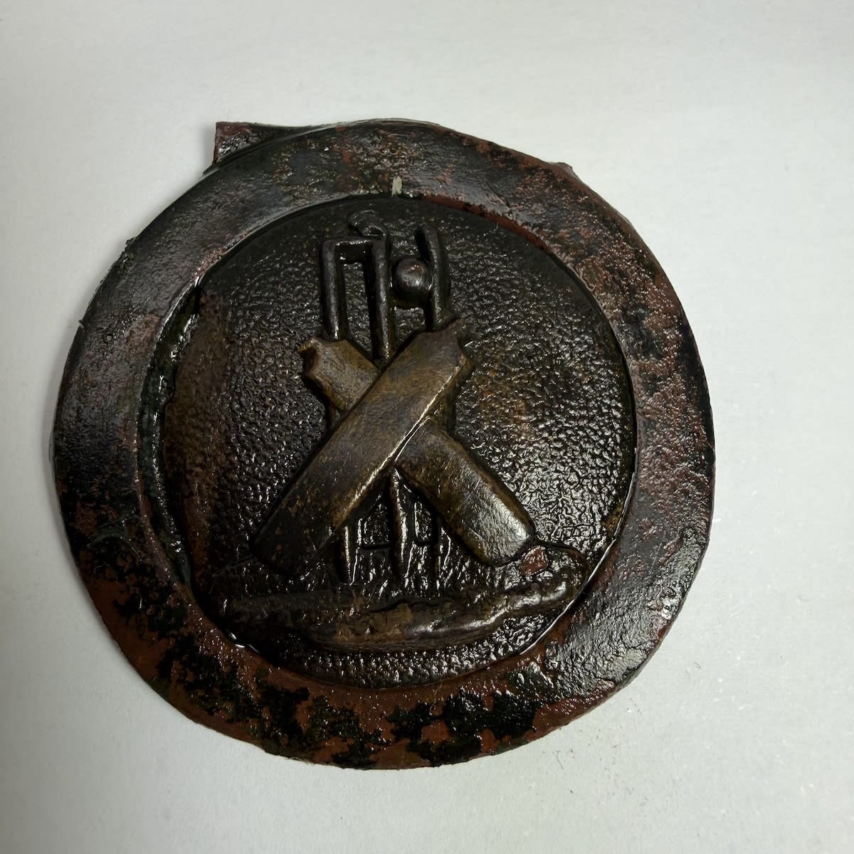 Cricket Belt Buckle. Crossed bats in front of stumps which have a ball going through them.