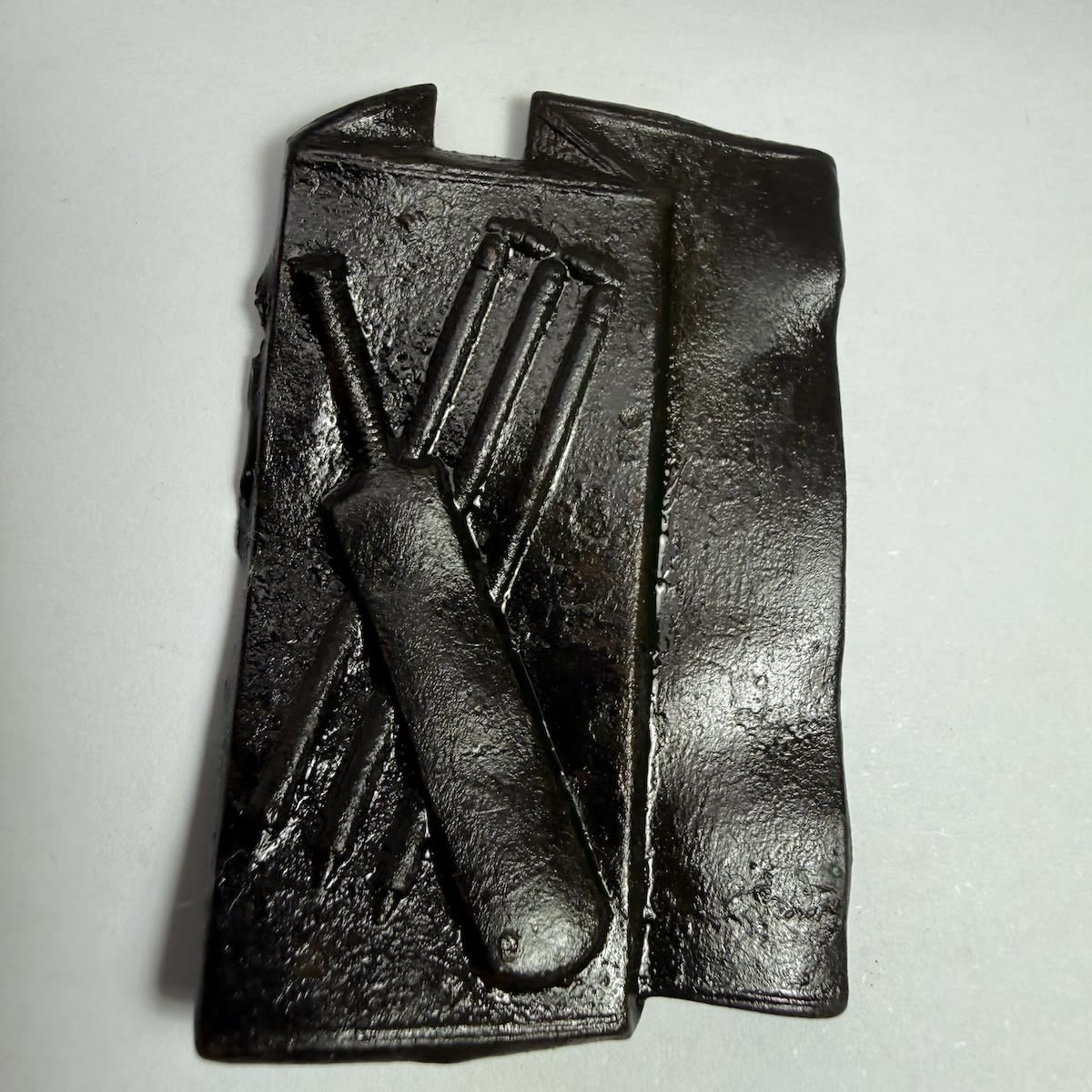 Cricket Belt Buckle. Front piece of a buckle with bat and stumps crossed.