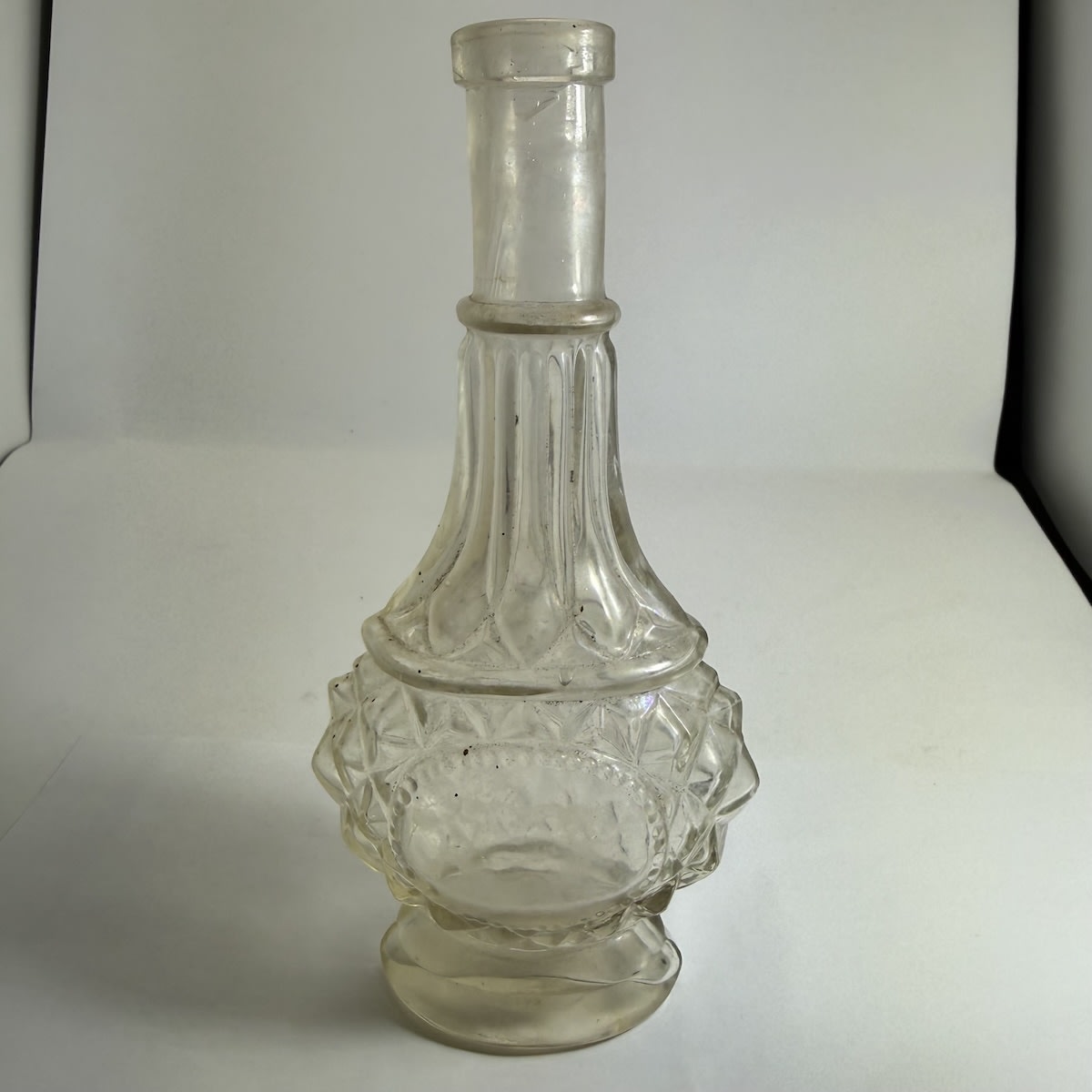 Perfume. Highly facetted body. Fluted neck. Spun finished top although it has the "Modern" AGM base mark. Clear. 4 oz. 182 mm.