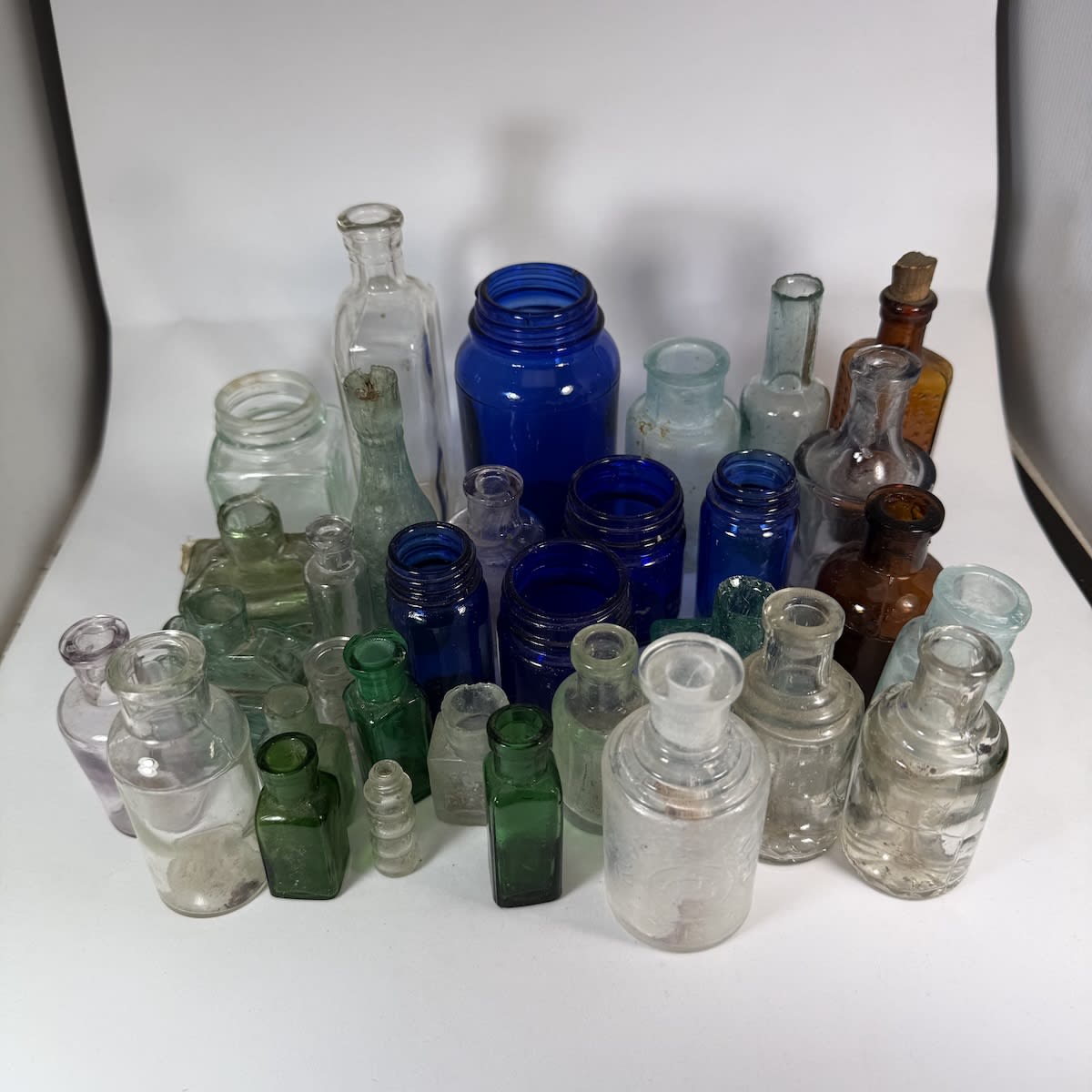 30 odd small bottles. Ink, Medicine, Essence etc.