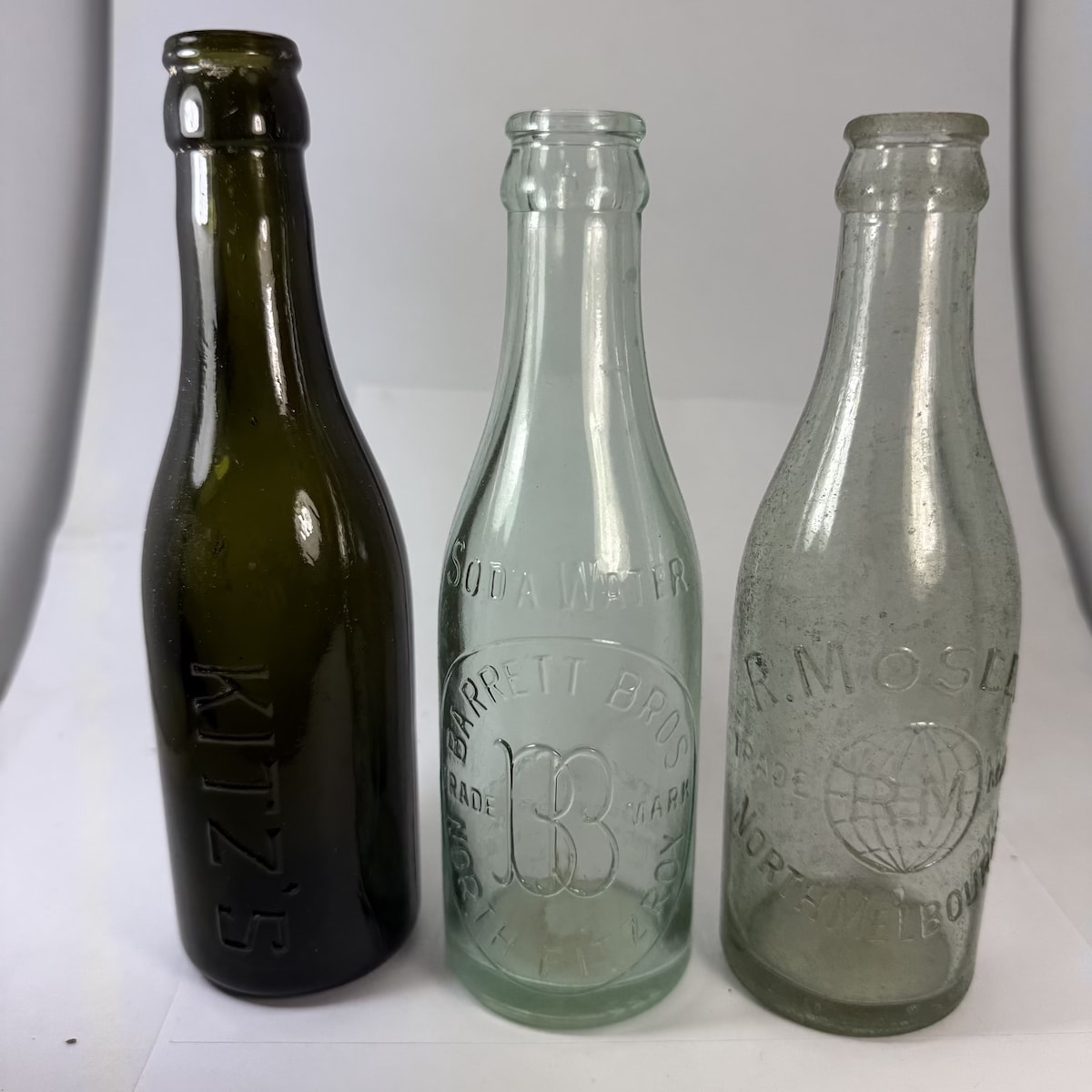 3 small Crown Seals: Green Kitz's; Barrett Bros, North Fitzroy; R. Mosley, North Melbourne. (Victoria)