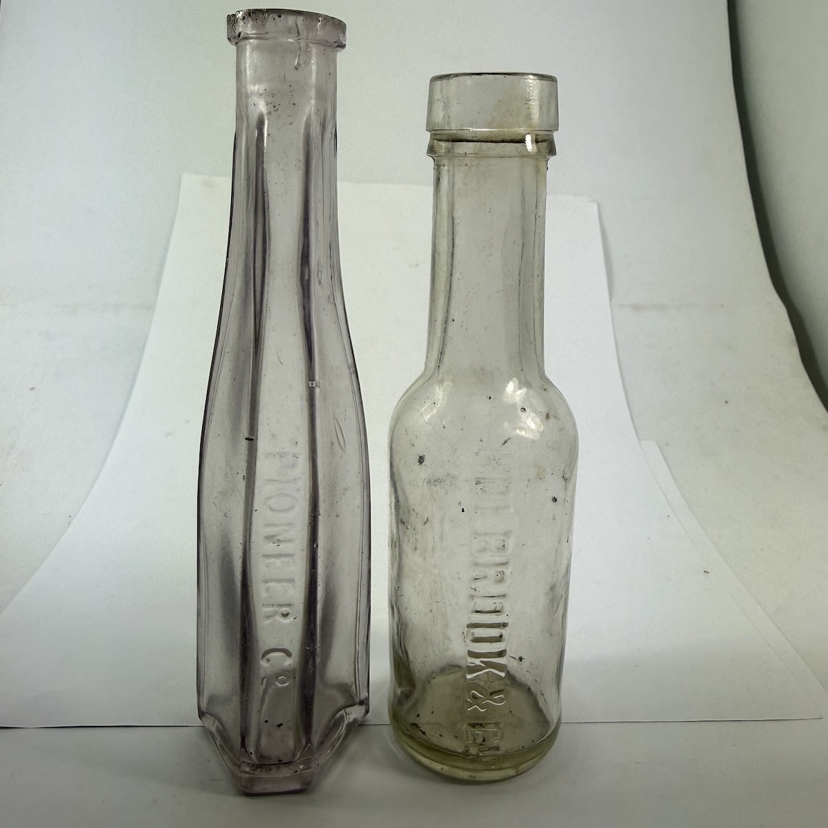 2 Sample Household Bottles: Pioneer Co; Holbrook & Co with Vulcan base mark.