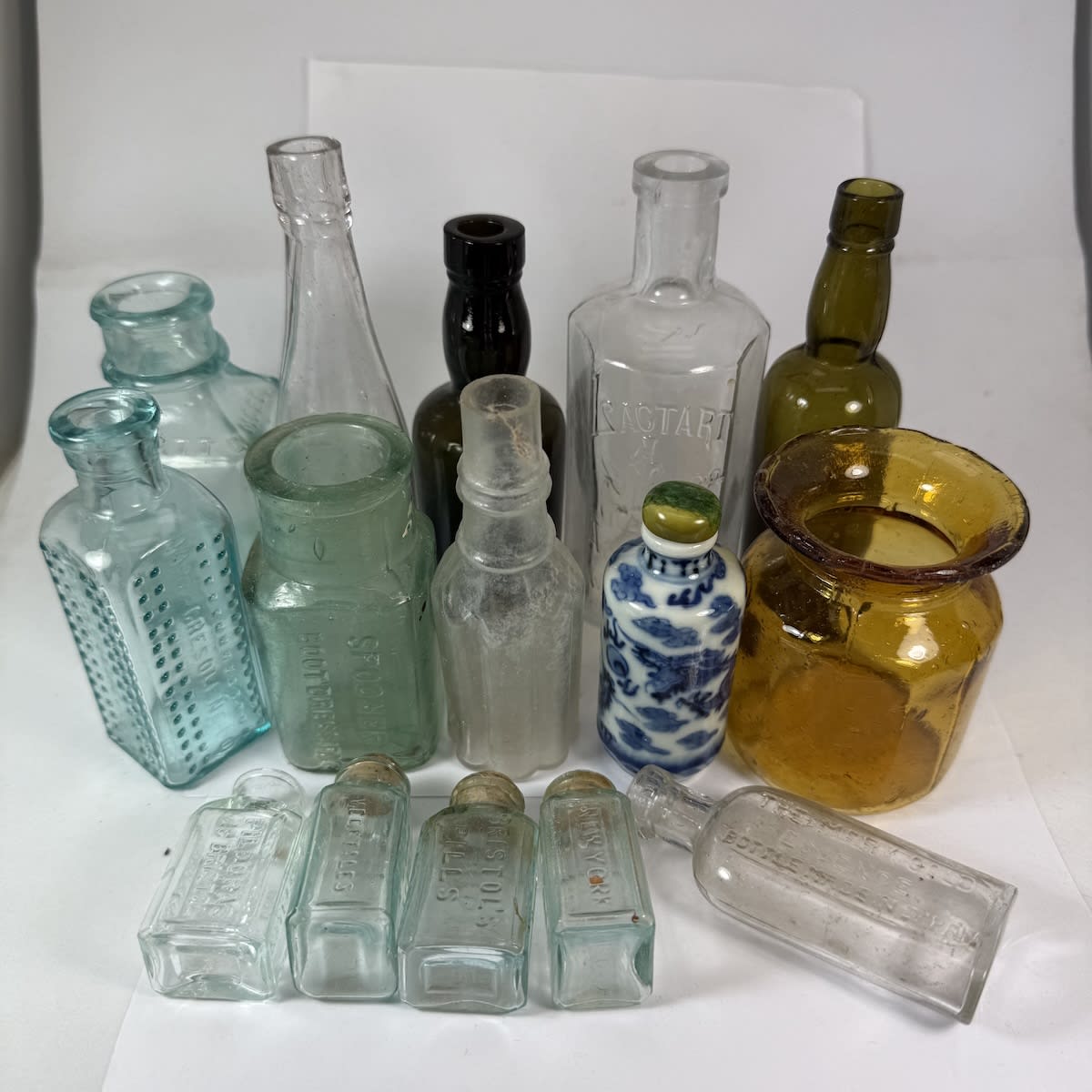 15 small bottles etc: Garrett wine; Polishes; Samples; Chinese snuff; 4 x Bristols Pills; Mary Gold Essence; Vase; etc.