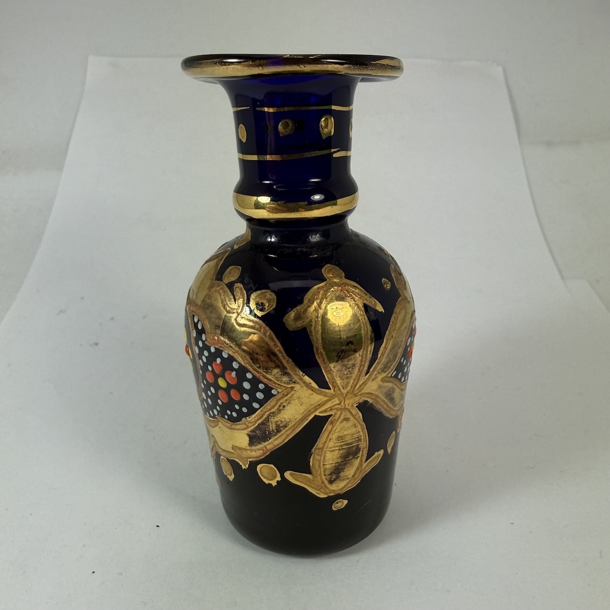 Small Cobalt Blue Perfume or vase. Gold Paint & enamel decoration. Pontil scar to base. 94 mm tall.
