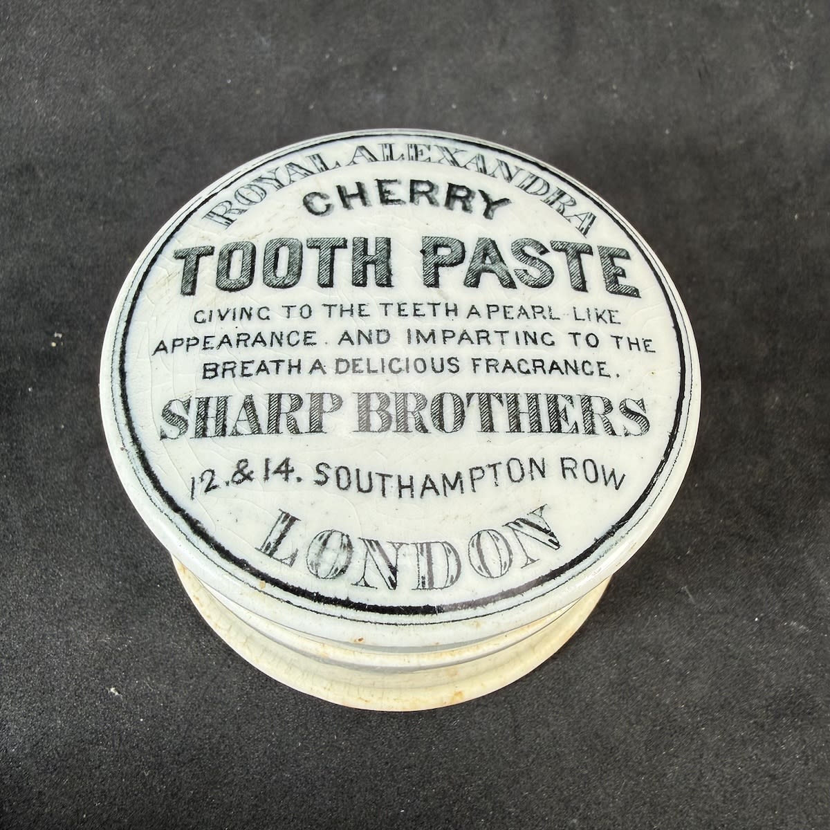 Pot Lid. Sharp Brothers, Royal Alexandra Cherry Tooth Paste. Southampton Row, London. Black & White small lid. With base.