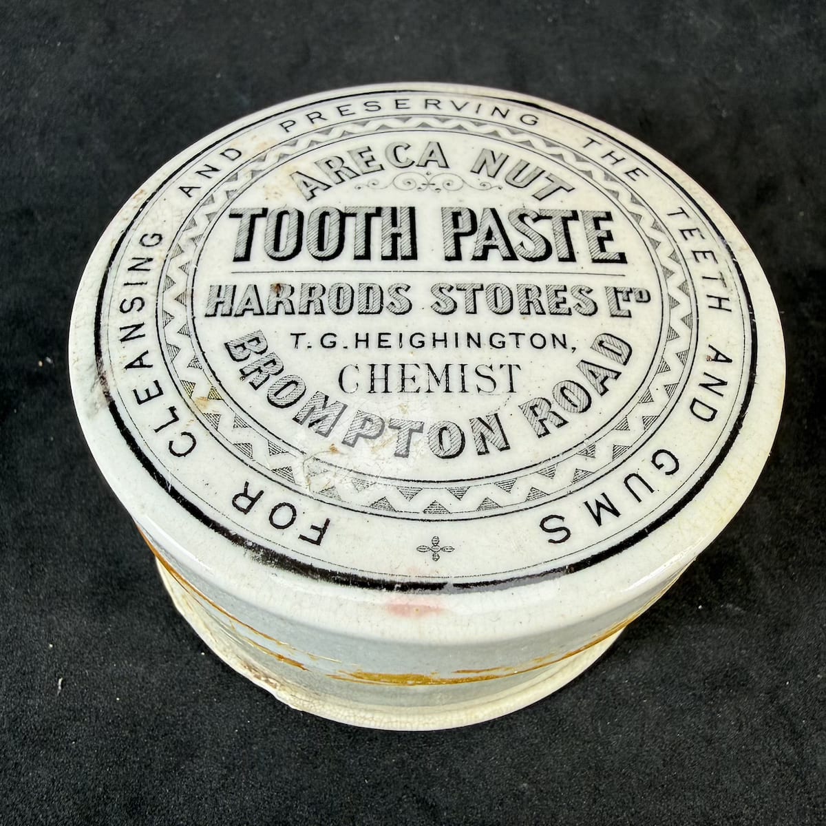 Pot Lid. Areca Nut Tooth Paste. Harrods Stores Ltd. T. G. Heighington, Chemist, Brompton Road. Larger round lid with a roughly fitting base.