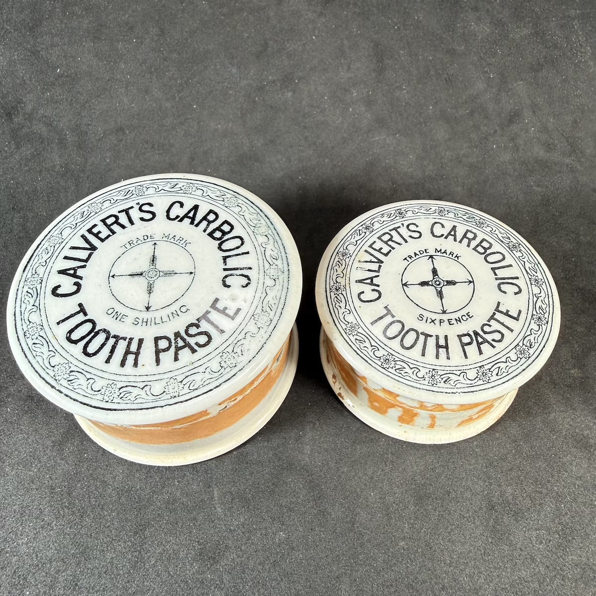 2 Pot Lids. Both Calvert's Carbolic Tooth Paste. One Shilling and Sixpence sizes. Black & White. With fitting bases.