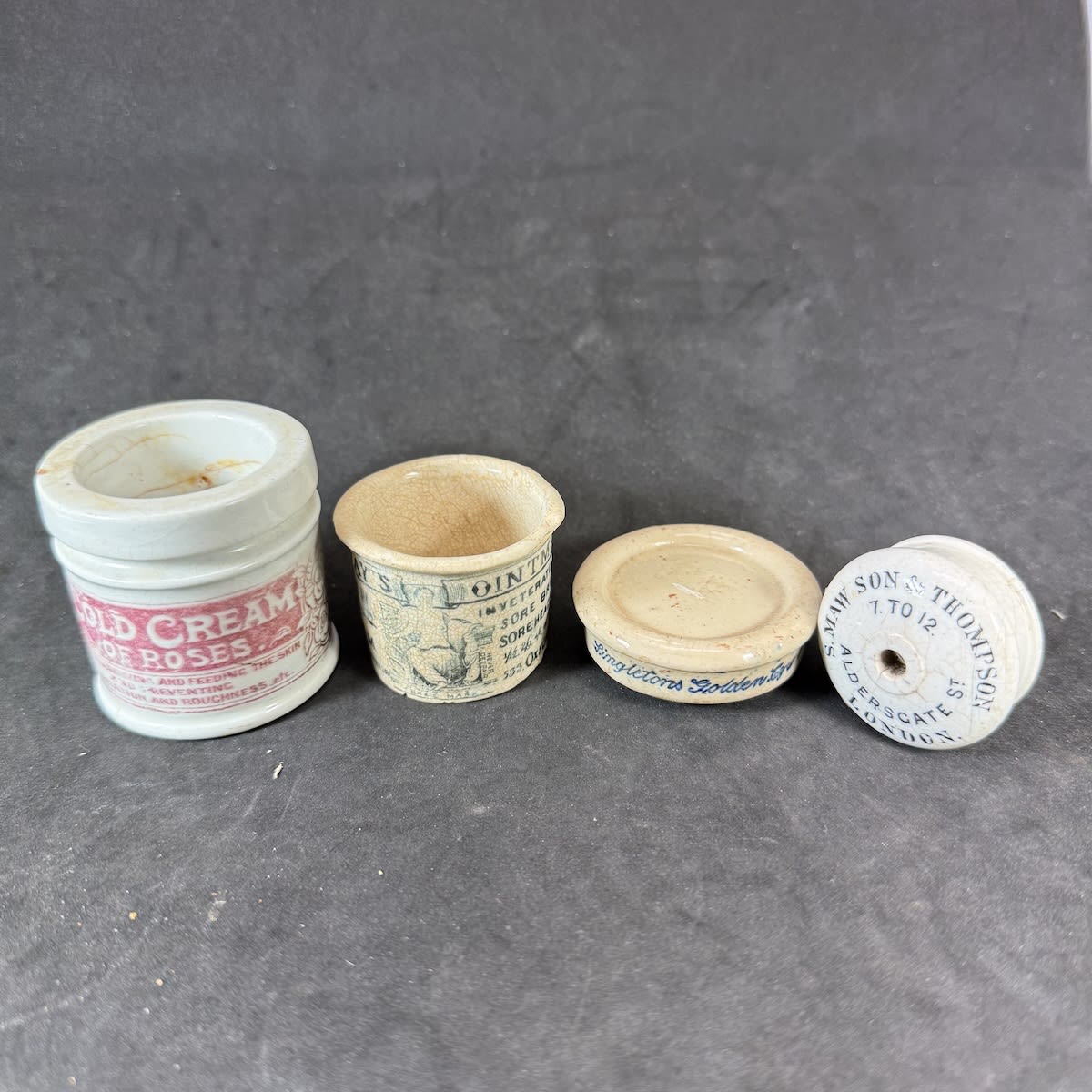 4 Pots and Pot Lids: Cold Cream of Roses; Holloways Ointment 533 Oxford Street; Singletons Golden Eye Ointment; S. Maw Son & Thompson Baby Feeder top.