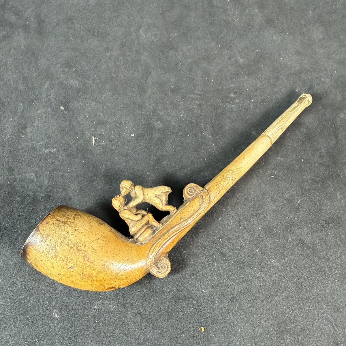 Meerschaum Clay Pipe. Risque figural decoration on top of the pipe, a couple kissing while one seems to be sitting on a chamber pot.