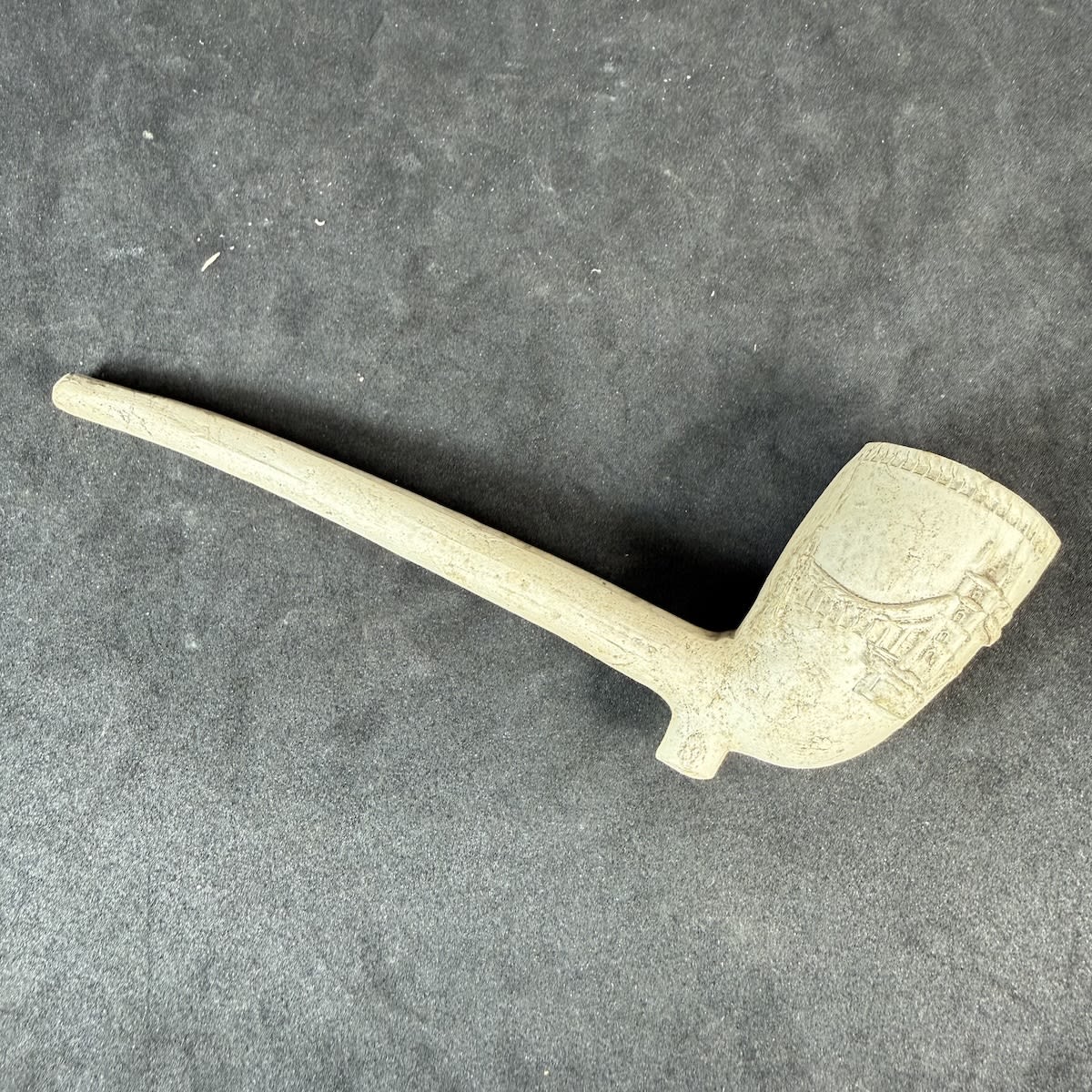 Clay Pipe. Fancy clay pipe with embossed decoration featuring London's Tower Bridge.