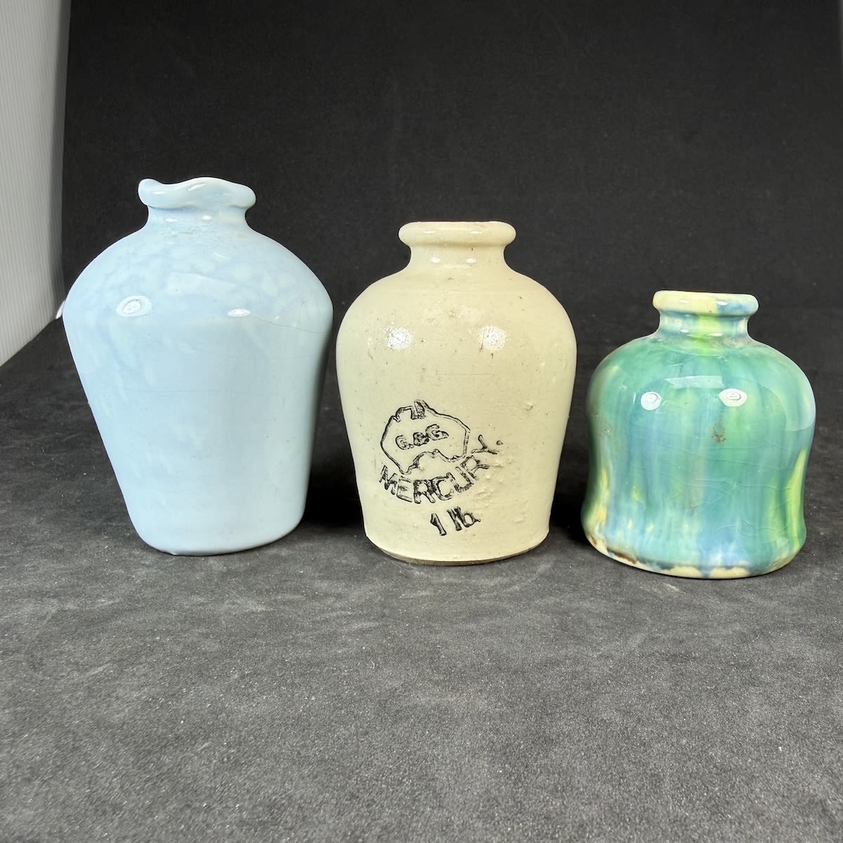 3 Dental Mercury Pots: Pale Blue tapered from shoulder to base; All White G. & G. in Map of Australia 1 lb.; Pinch waisted Green majolica glaze.