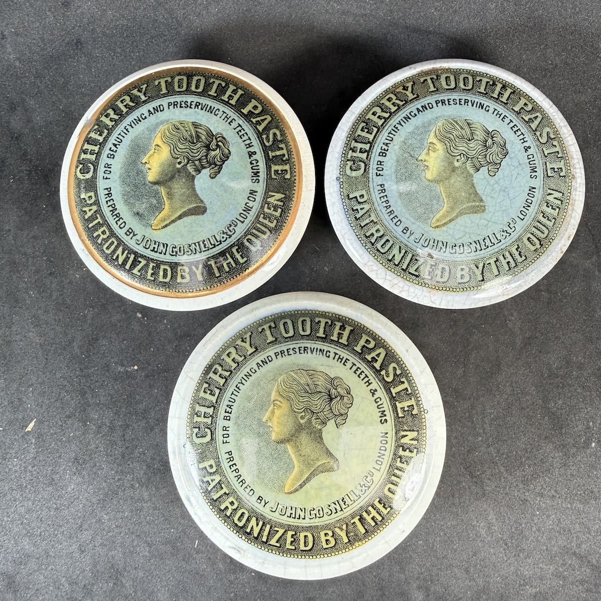 3 John Gosnell & Co Cherry Tooth Paste Queens Head Pot Lids. All Coloured variations. One with correct Queens Head style base, the other two with fitting straight sided bases.