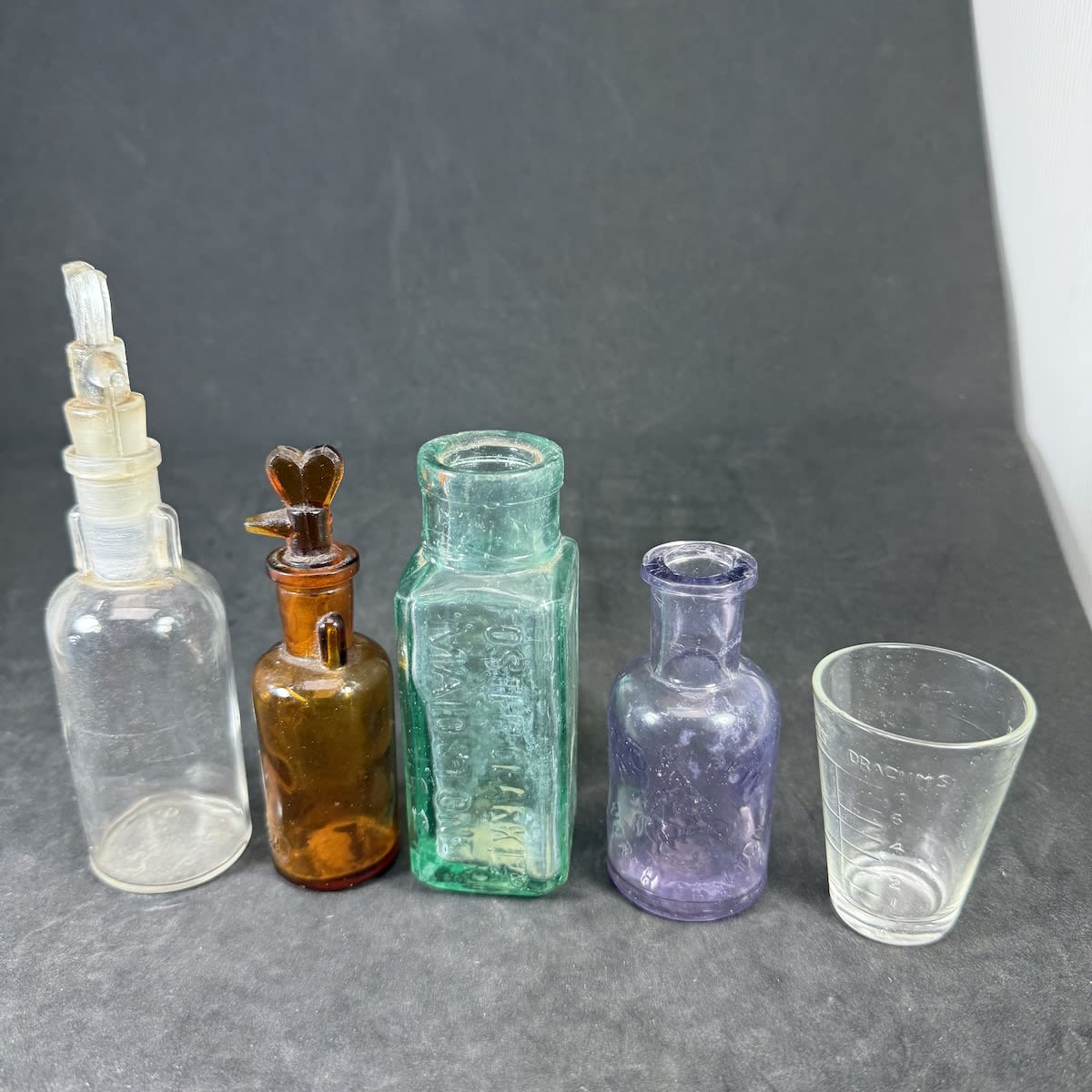 5 Small Items: 2 Ether Dropper types in Clear & Amber; Eiffel Tower Lemonade; A. C. Parkin North Carlton Essence; 2 Table Spoon dose cup.