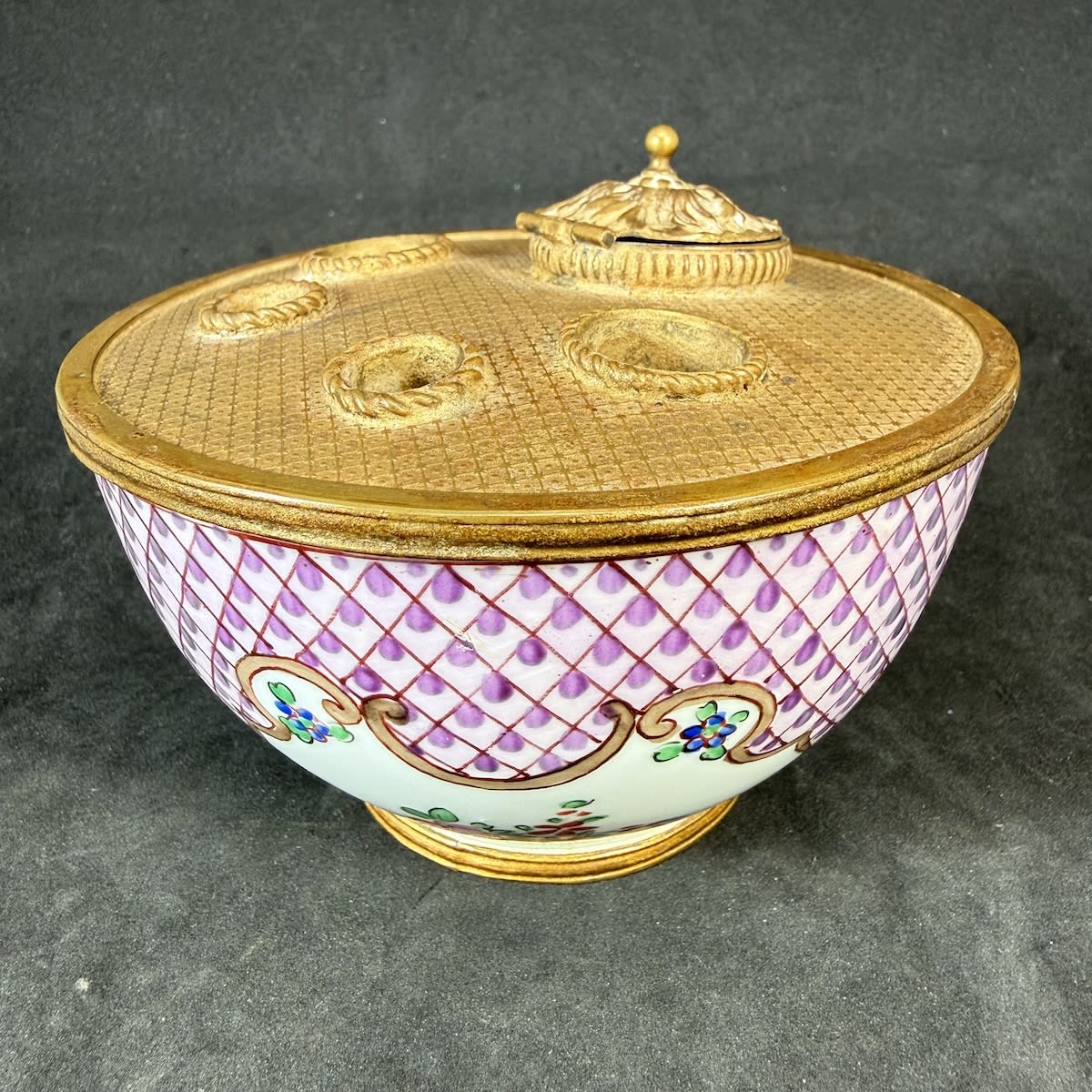 Inkwell. French Porcelain hand decorated bowl with copper or similar top with pen holders and lidded well. Made in France in gold lettering on the base.