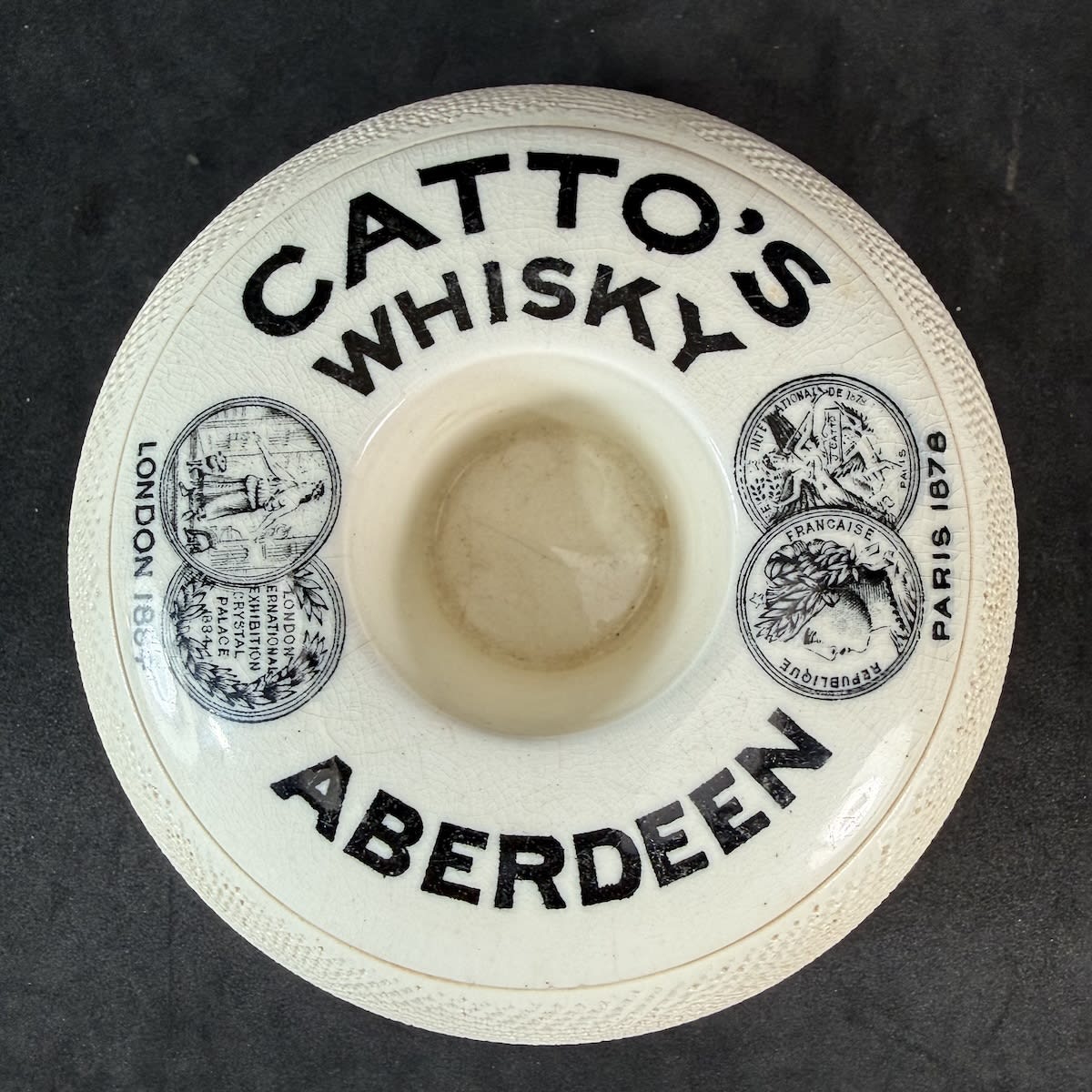 Advertising Match Striker. Catto's Whisky Aberdeen. Donut shaped. Medals printed. Hunt & Frenkel Blackfriars London maker.